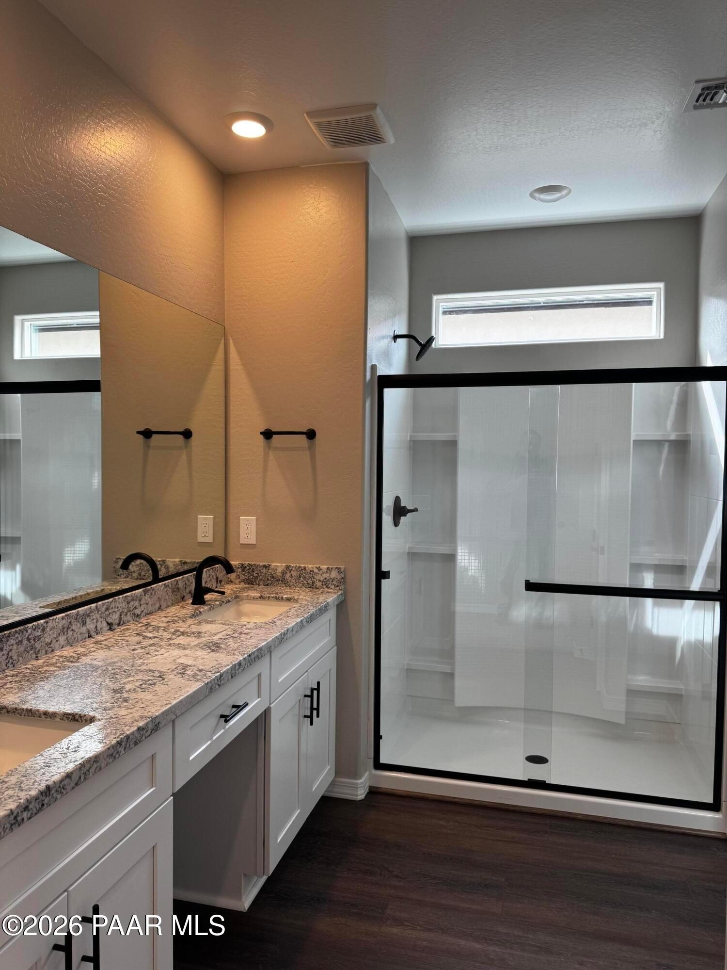 Modern master bathroom featuring double quartz vanity, frameless glass shower in Davidson Homes Durango II B, Prescott AZ