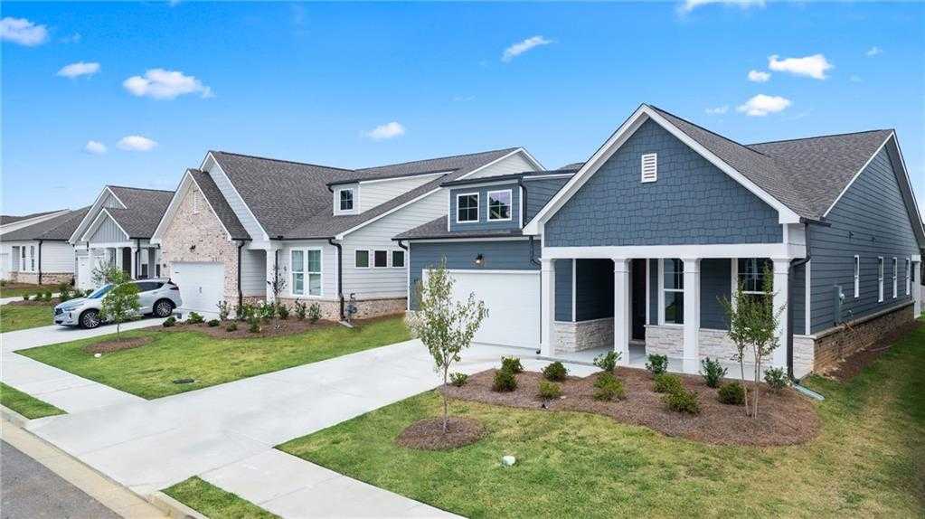 Modern Davidson Homes exteriors in Kelly Preserve, Loganville, GA: 3-bed The Edison A with 2-car garages, blue siding, and manicured lawns