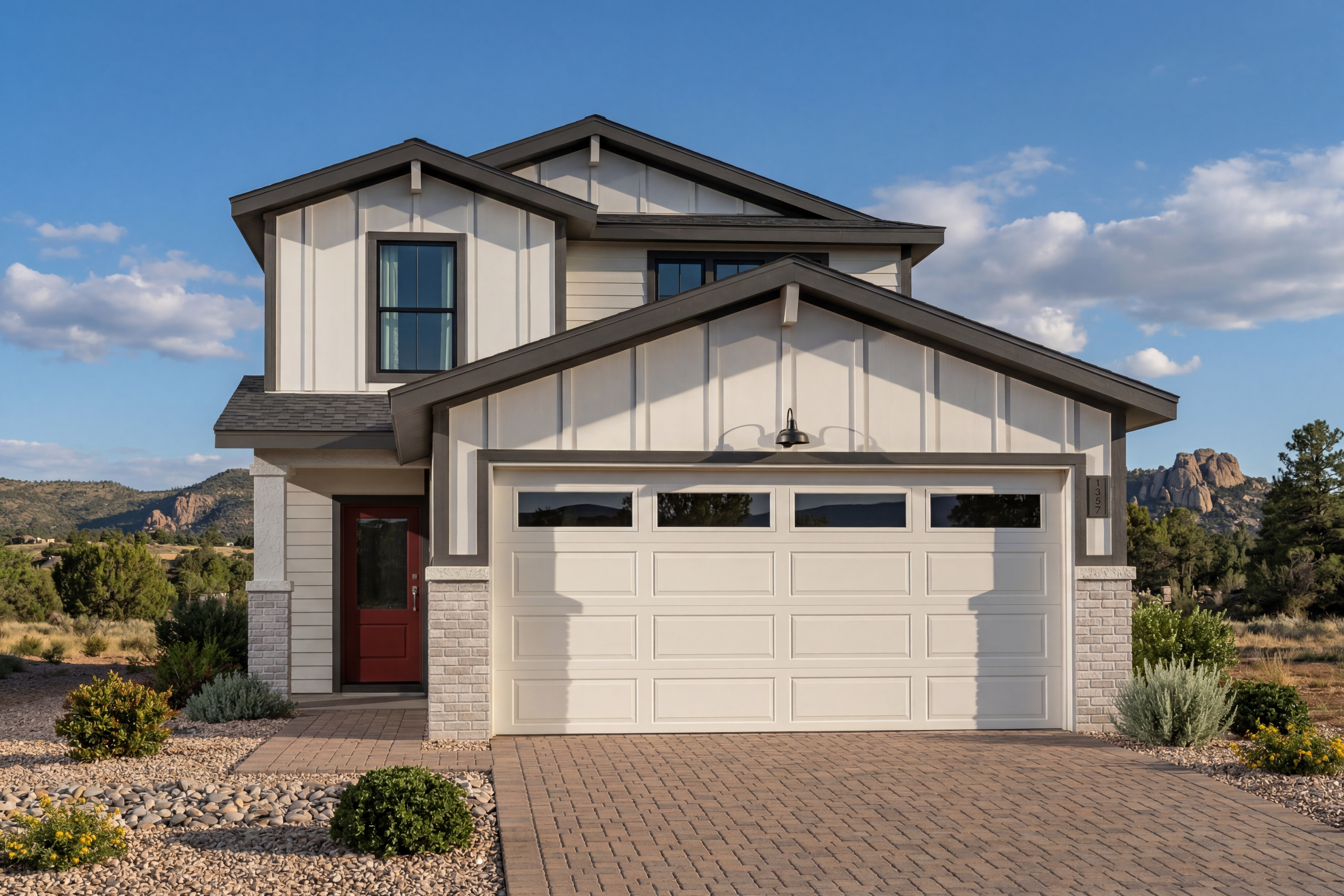Modern farmhouse exterior of The Wilmington B in Prescott, Arizona, featuring white siding, stone accents, and a garage.