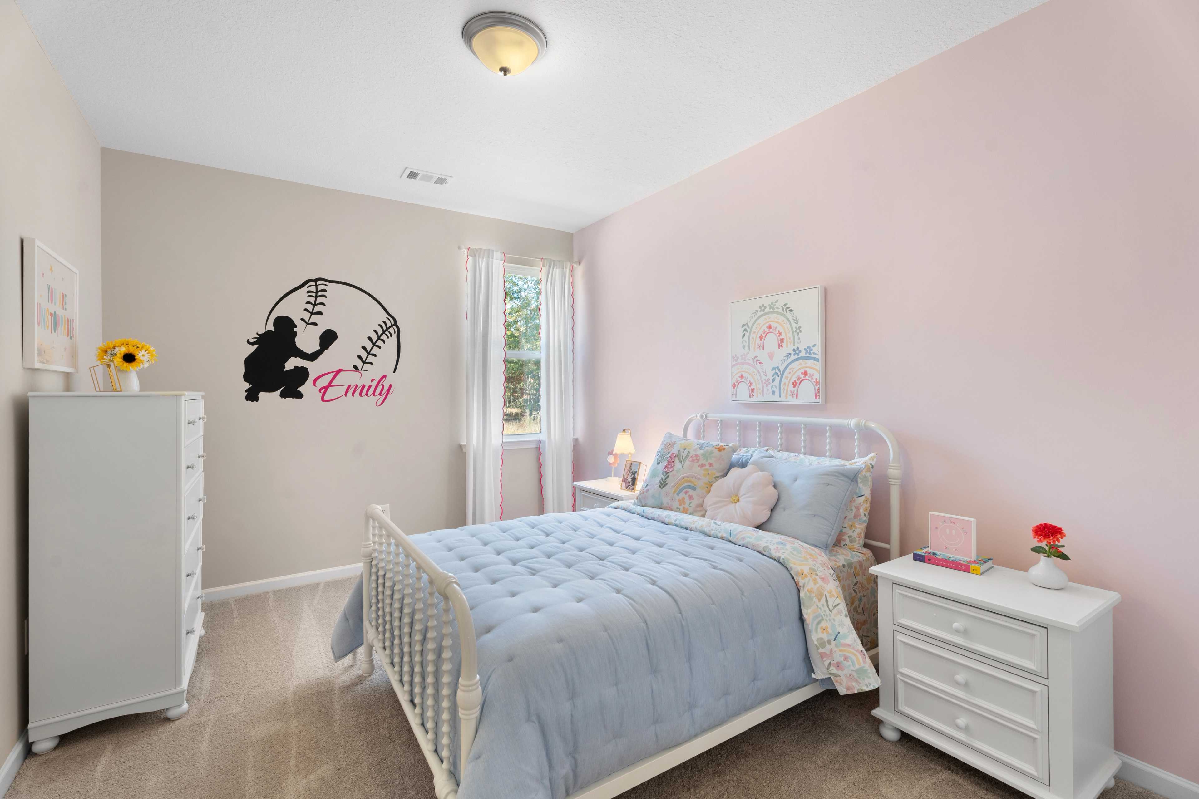 Baseball-themed girl's bedroom at Silver Oak in Cusseta Alabama by Evermore Homes with pink walls, white bed, and Emily bat silhouette