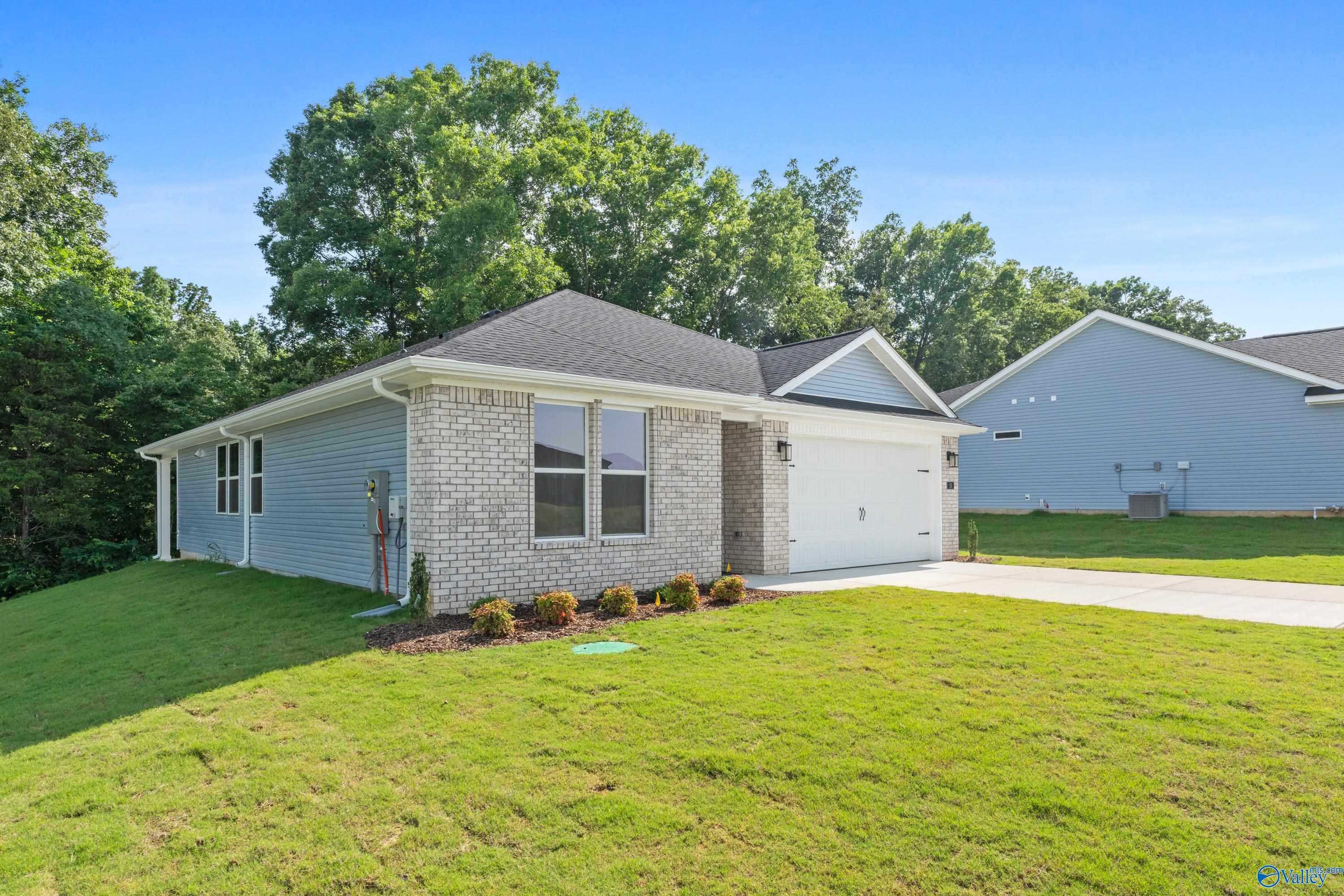 Modern 1-story Davidson Homes Polaris with brick facade, 2-car garage, and green lawn in Bailey Park, Fayetteville, TN