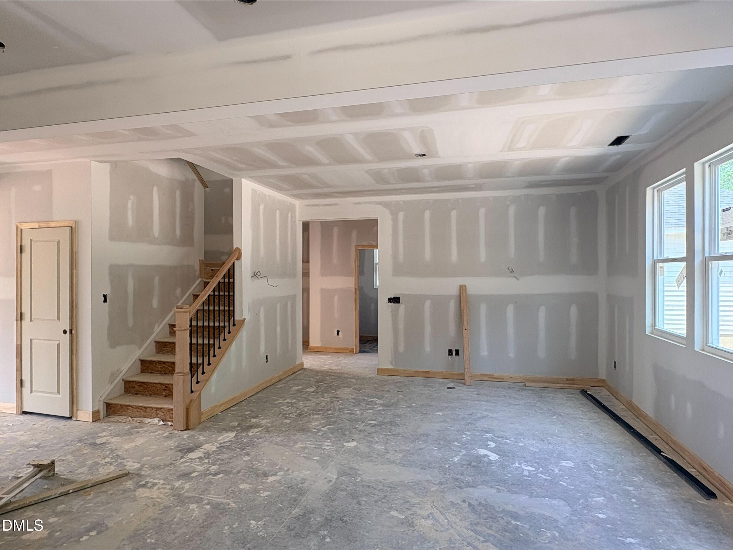 Unfinished living area with staircase in The Willow B floor plan by Davidson Homes at Woodland Crossing in Zebulon, NC.