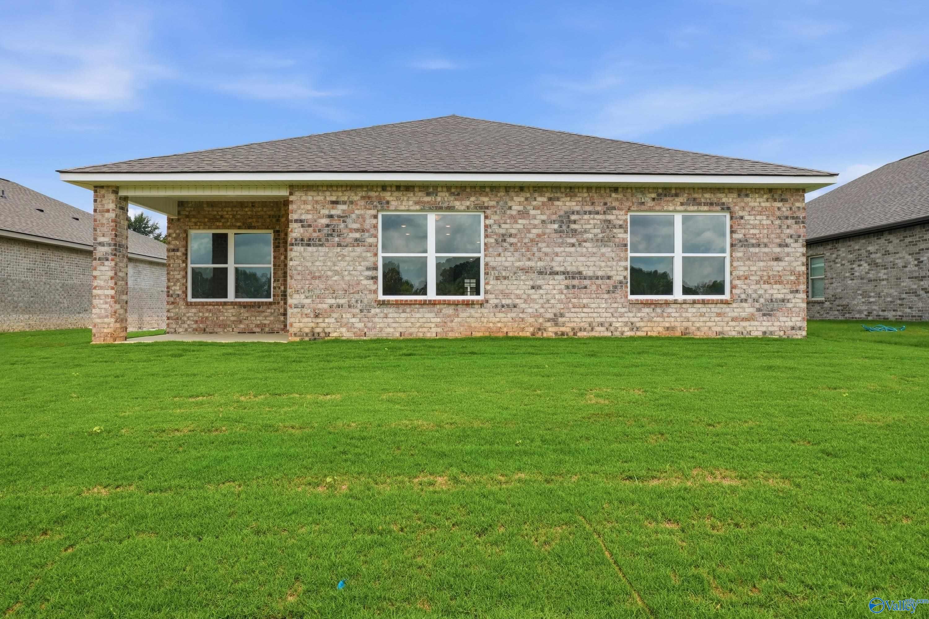 Back exterior view of The Daphne floor plan by Davidson Homes featuring a brick façade in Lynn Meadows, Meridianville, AL.