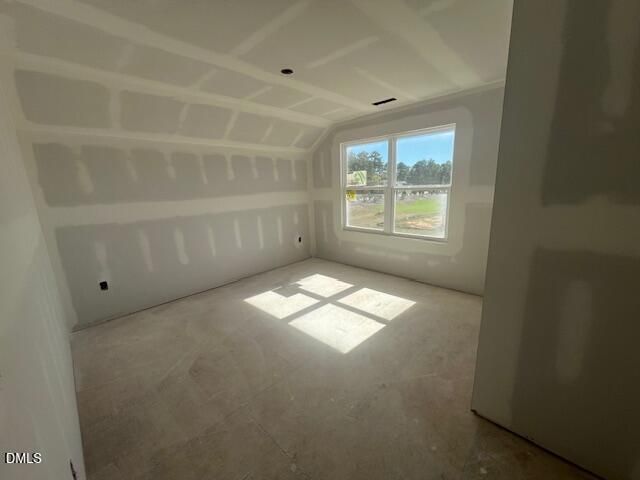 Unfinished bedroom with vaulted ceiling and window view in Davidson Homes The Ash C plan, Lillington, North Carolina