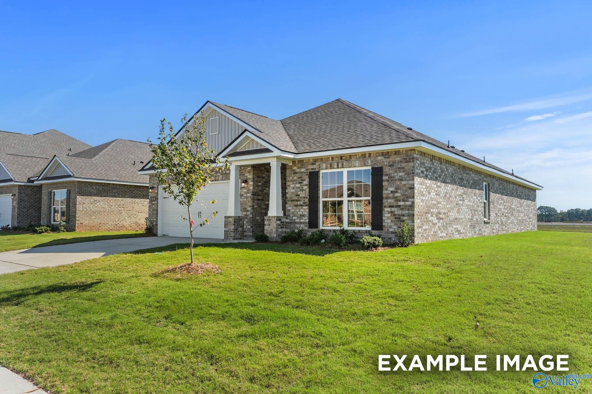 Modern 1-story brick home with gabled roof, 2-car garage, and lush green lawn in Ricketts Farm, Athens, Alabama - Davidson Homes Daphne C