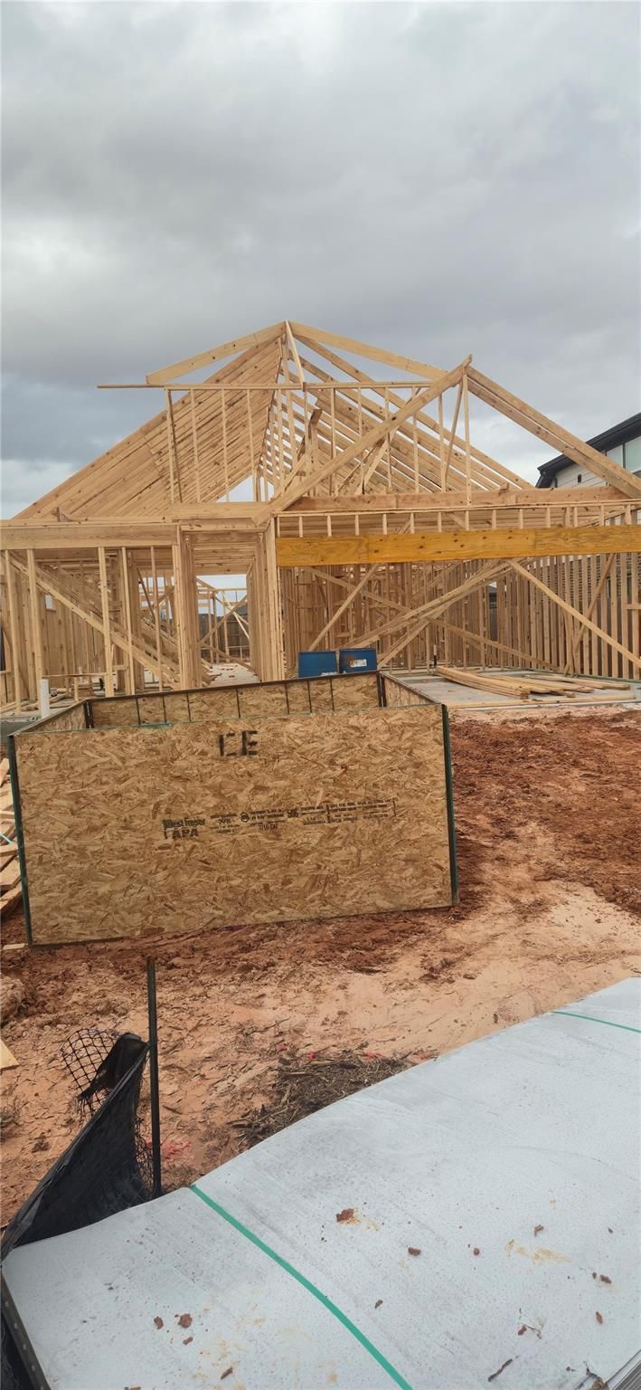 Wooden framing of 1-story 4-bedroom Davidson Homes The Luna J under construction in Sunterra, Katy, Texas