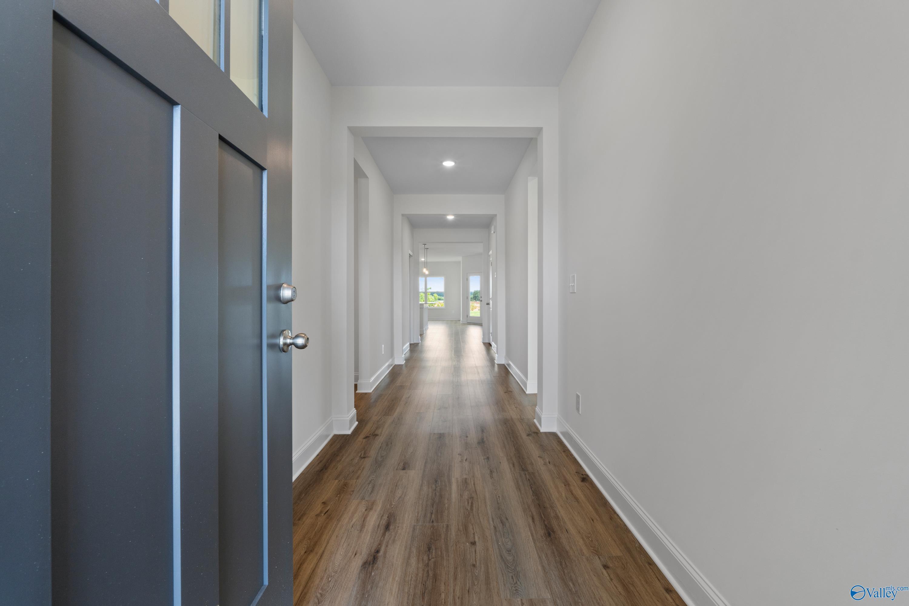 Bright foyer entrance with wood-look flooring in The Everett B floor plan by Davidson Homes in The Meadows, Athens, AL.