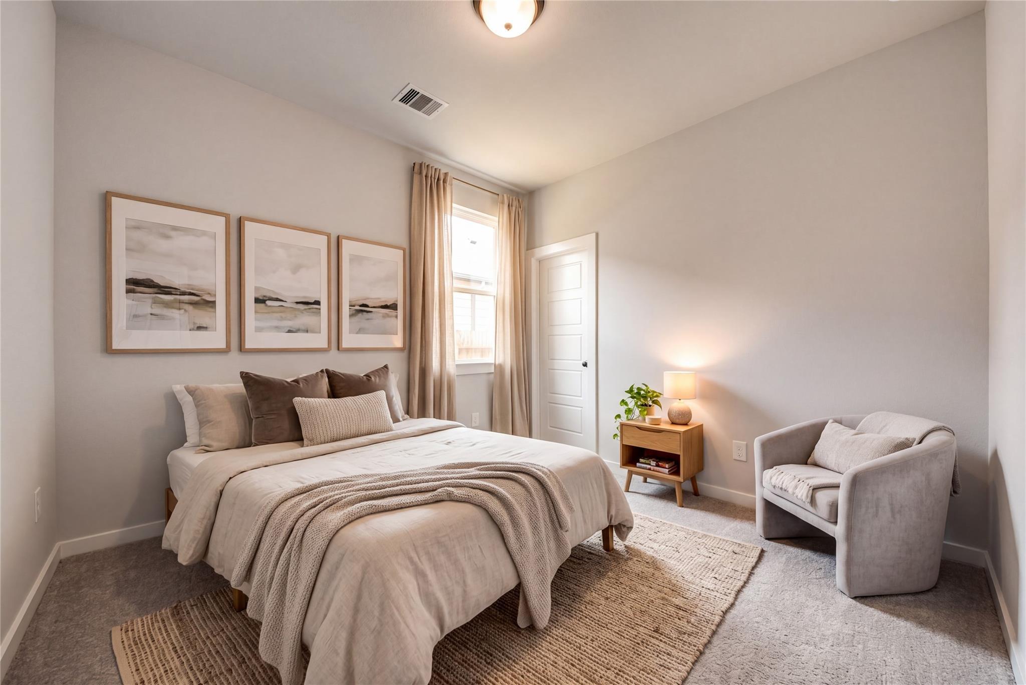 Serene neutral bedroom with cozy bedding, accent chair, and gallery wall in Davidson Homes The Daphne F, Sundance Cove, Crosby, TX