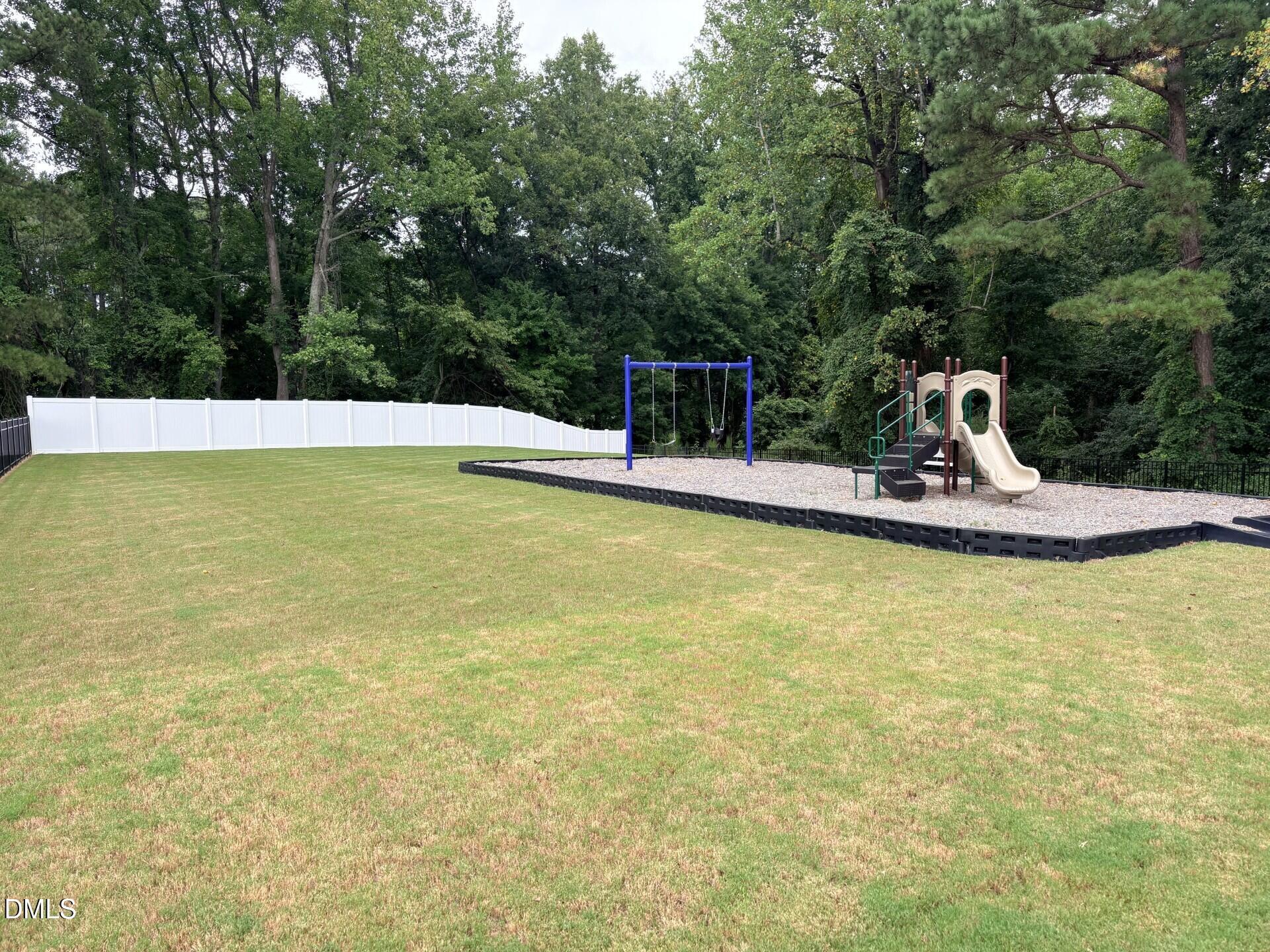 Spacious backyard with a private playground in the Woodland Crossing community, Zebulon, North Carolina.