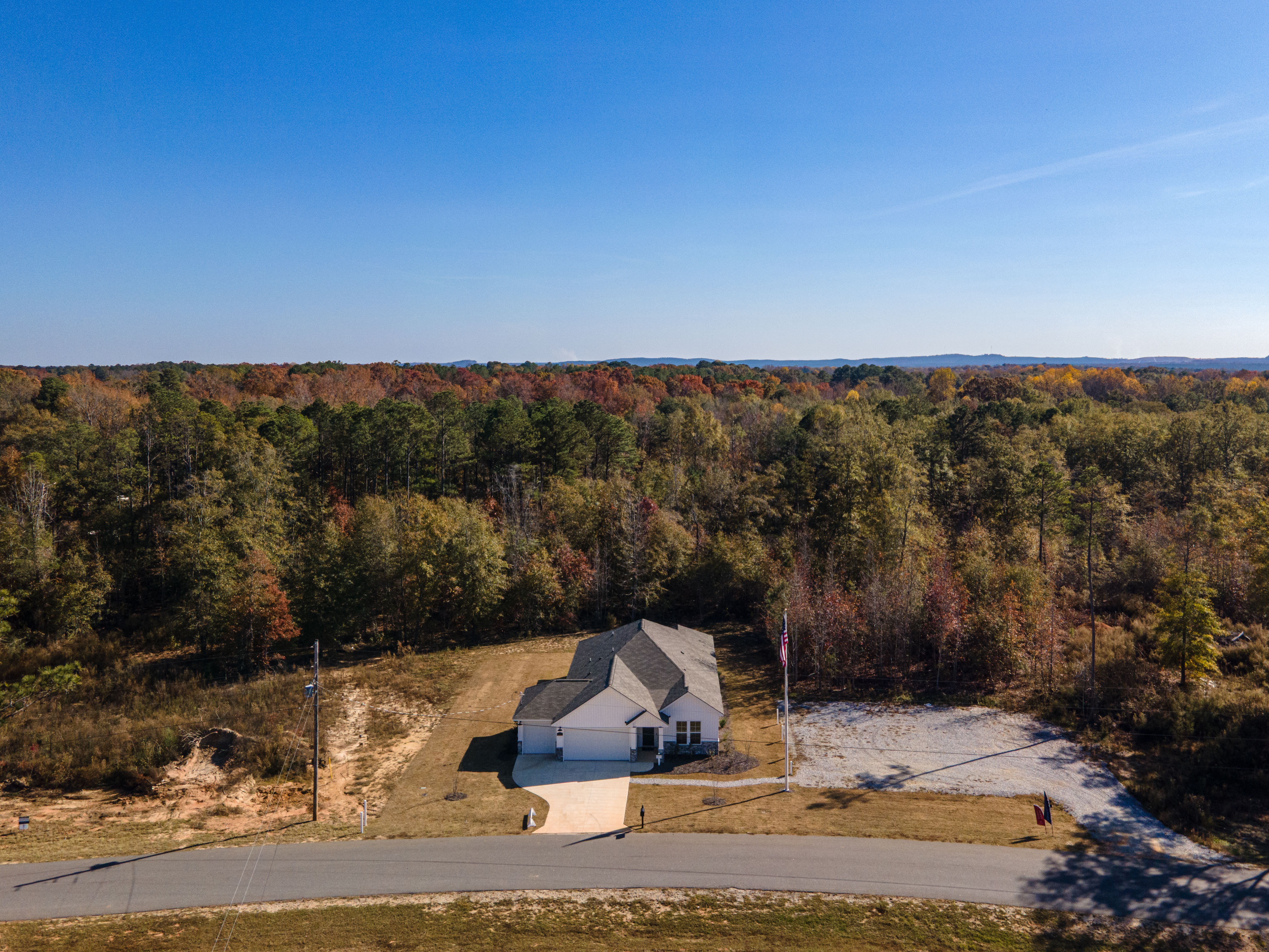Aerial view of modern single-story home at Silver Oak in Cusseta Alabama with wooded surroundings