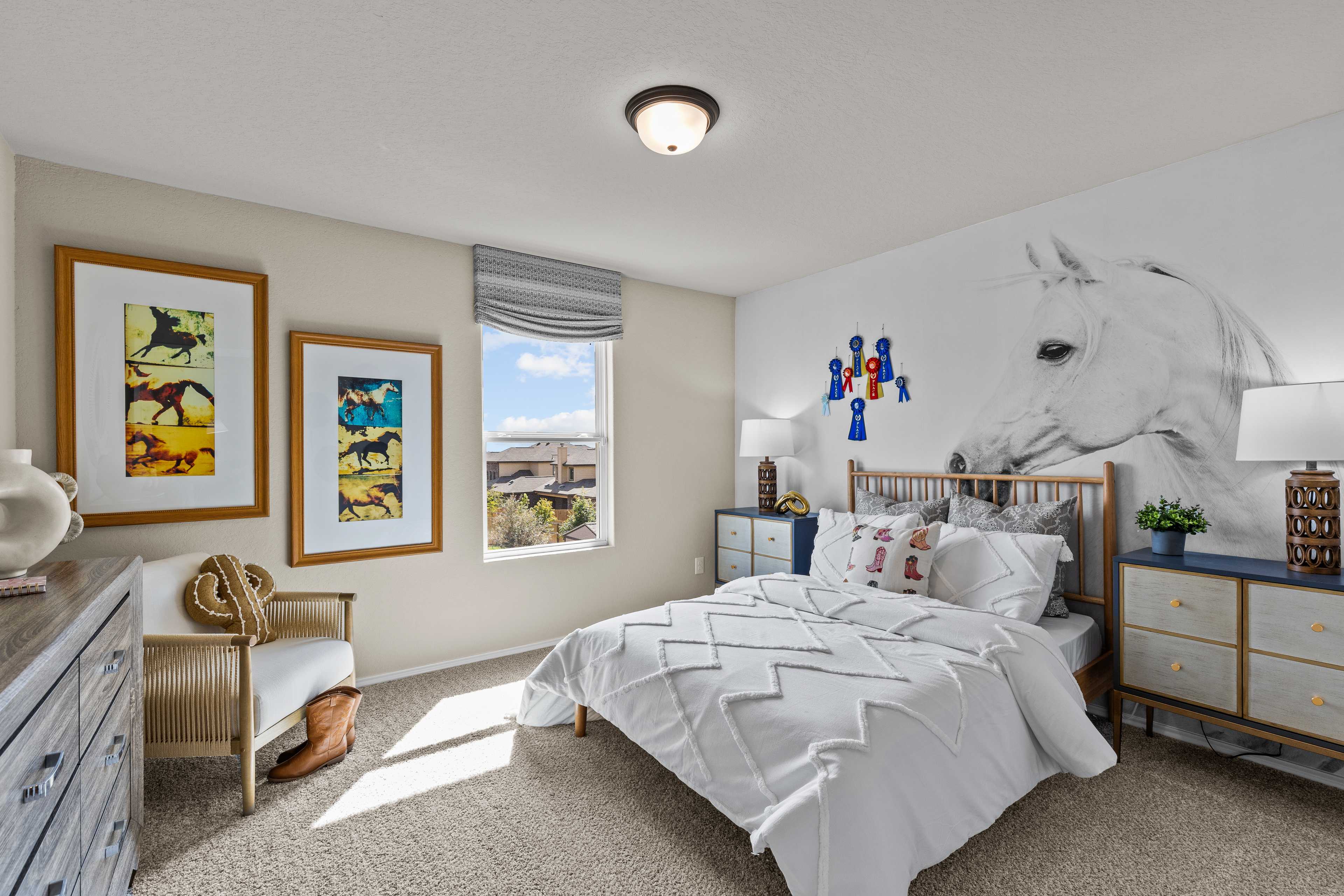 Charming kids' bedroom at Bricewood in San Antonio TX by Davidson Homes featuring horse mural, twin bed with white quilt, and wooden furniture