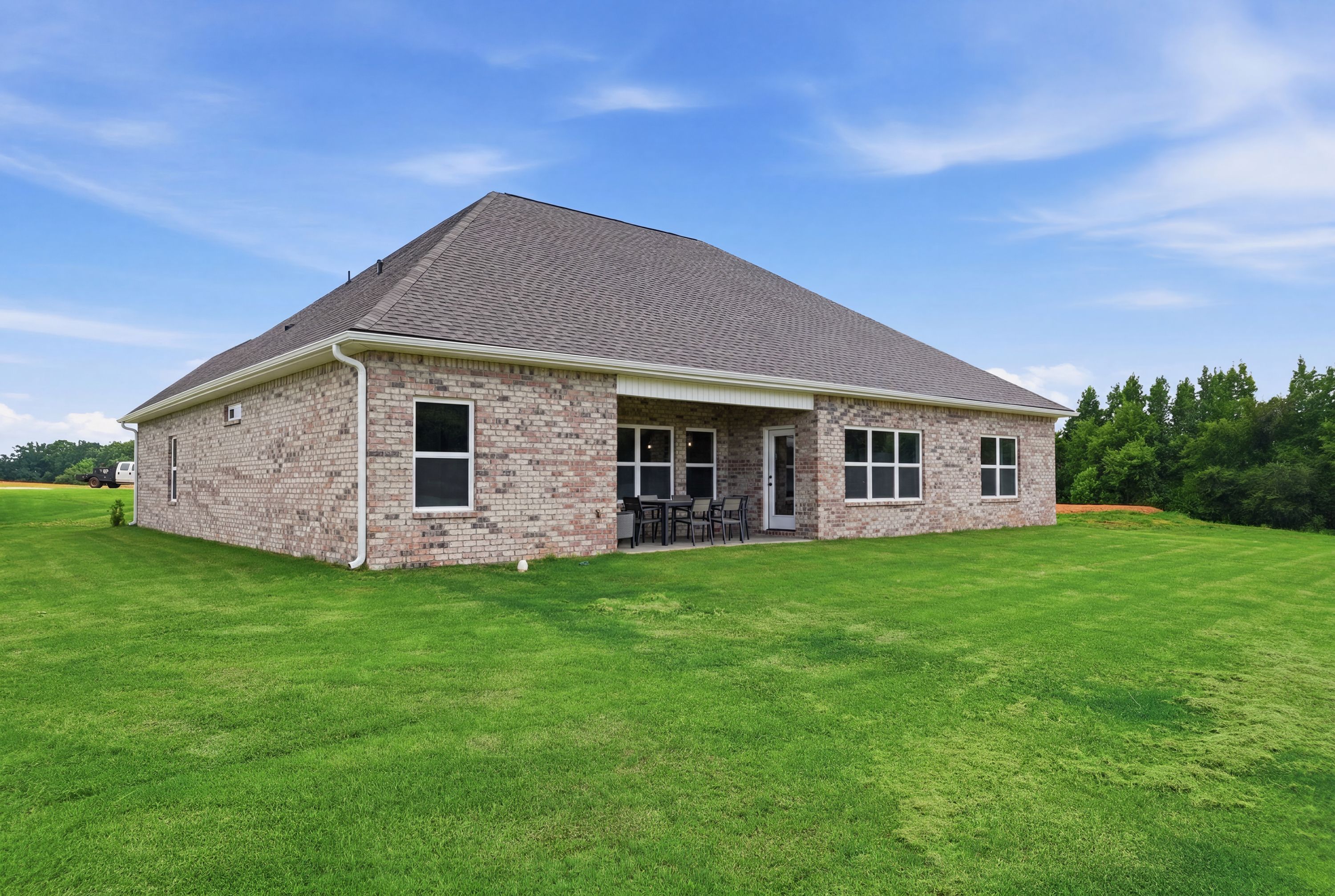Davidson Homes exterior at Riverton Preserve in Huntsville, Alabama featuring a brick home with a covered back patio.