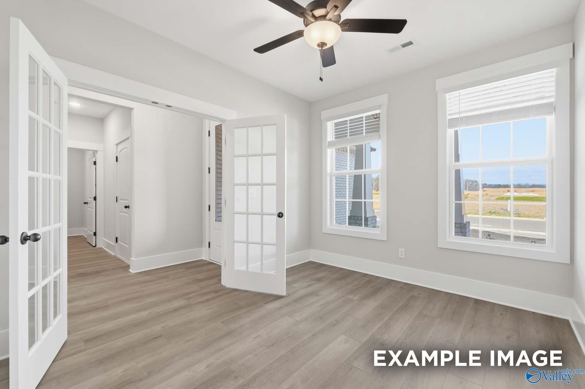 Bright home office or flex room with French doors and wood-look flooring in The Rockford floor plan, Meridianville, AL.