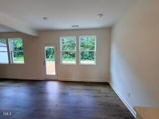 Bright, open-concept living area with hardwood floors in The Willow B floor plan at Woodland Crossing, Zebulon, NC.