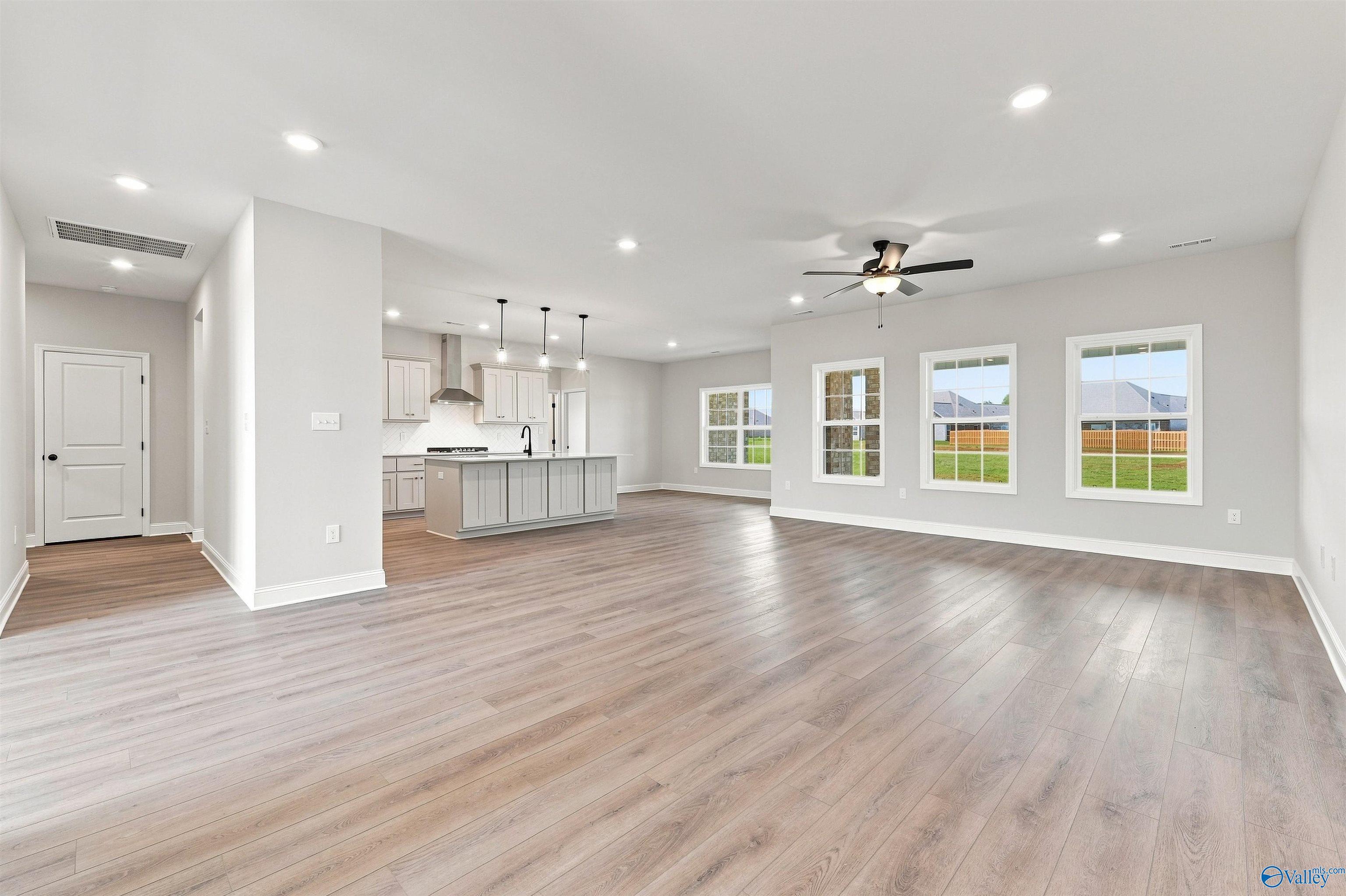Open-concept living room and kitchen in The Oxford floor plan by Davidson Homes at Kendall Farms in Toney, Alabama.