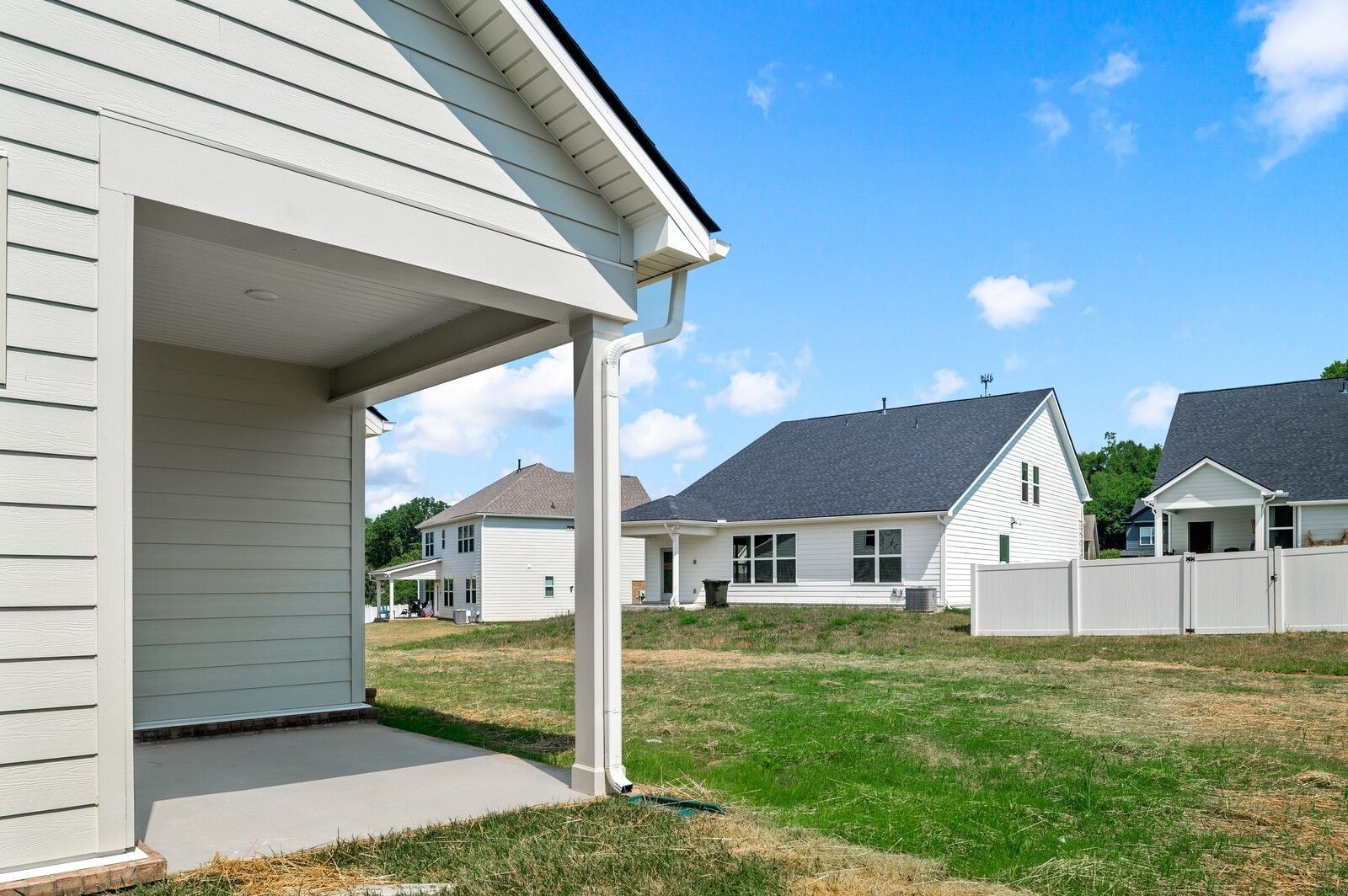 Covered patio overlooking private backyard in Woods Crossing, Gallatin, Tennessee, featuring The Ash A floor plan.