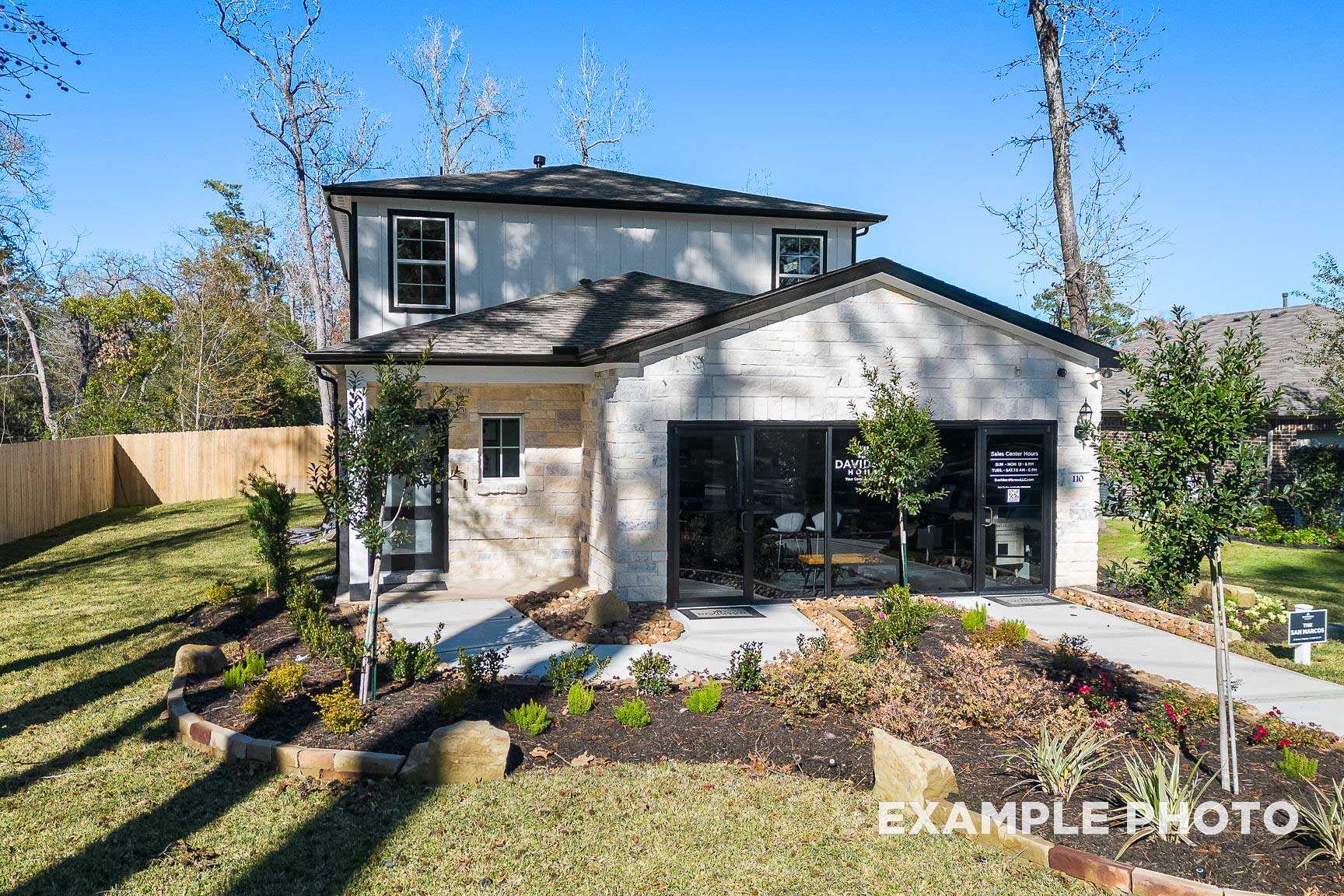Modern two-story San Marcos home exterior by Davidson Homes in Beasley Texas with white siding, two-car garage, and landscaped front yard
