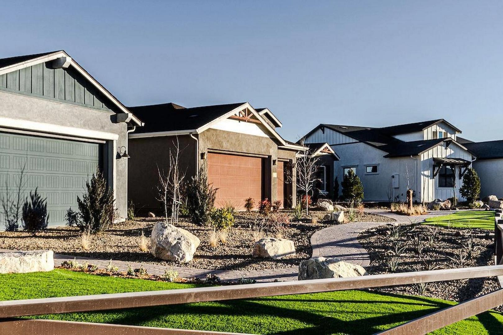 Row of modern homes with garages, stone landscaping, pathway and fence in Westwood, Prescott AZ by Davidson Homes