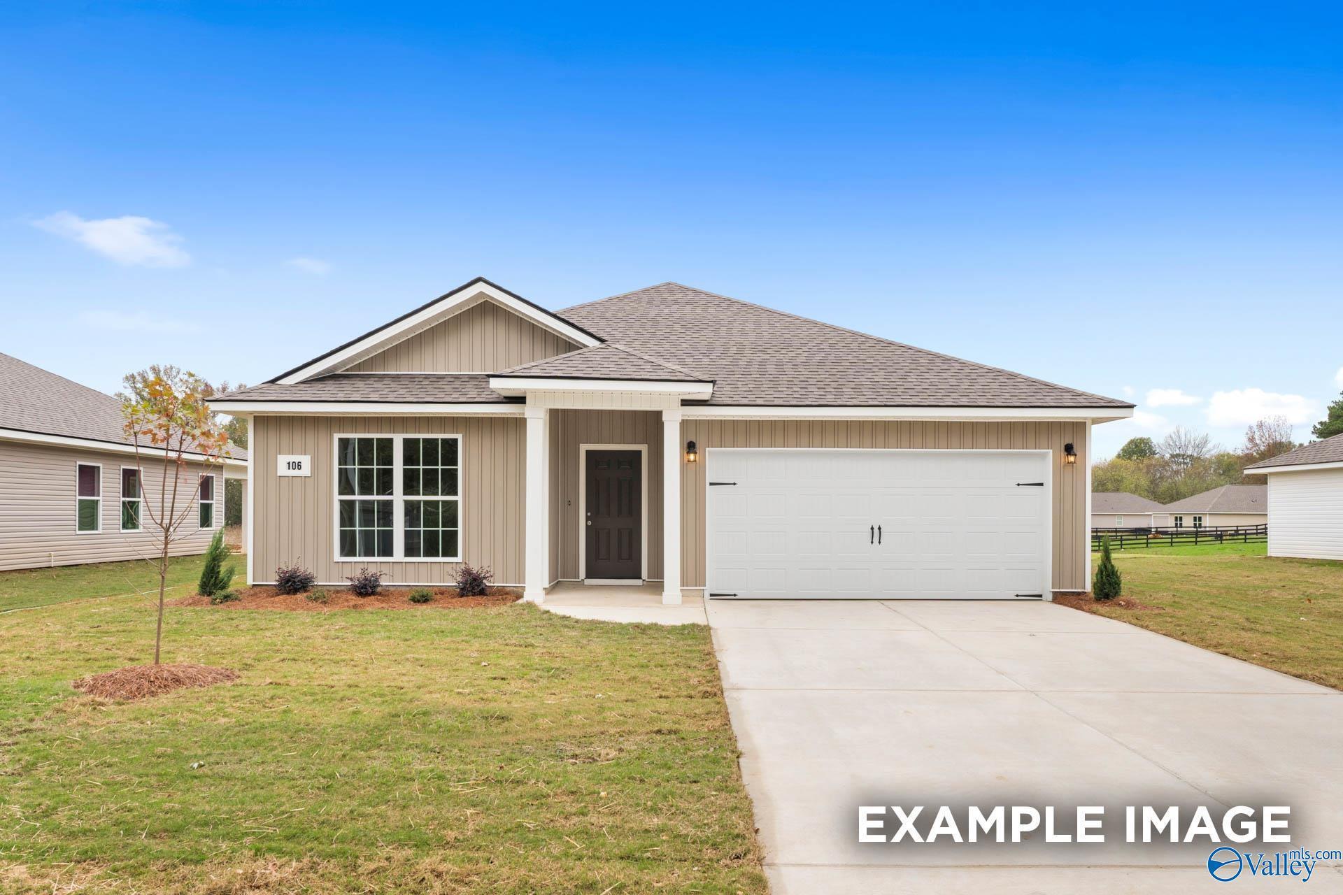 Modern beige single-story home with shake siding, covered porch, 2-car garage, lush lawn in Chapel Hill, Athens, Alabama - Davidson Homes The Daphne V