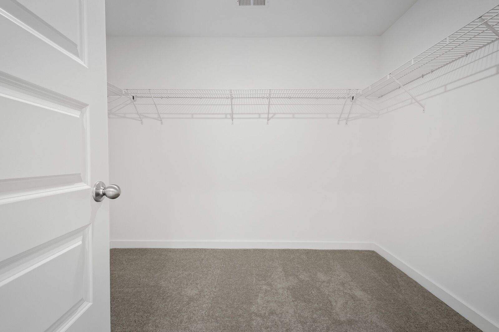 Spacious walk-in closet with wire shelving in The Logan C floor plan at Calista Farms in White House, Tennessee.