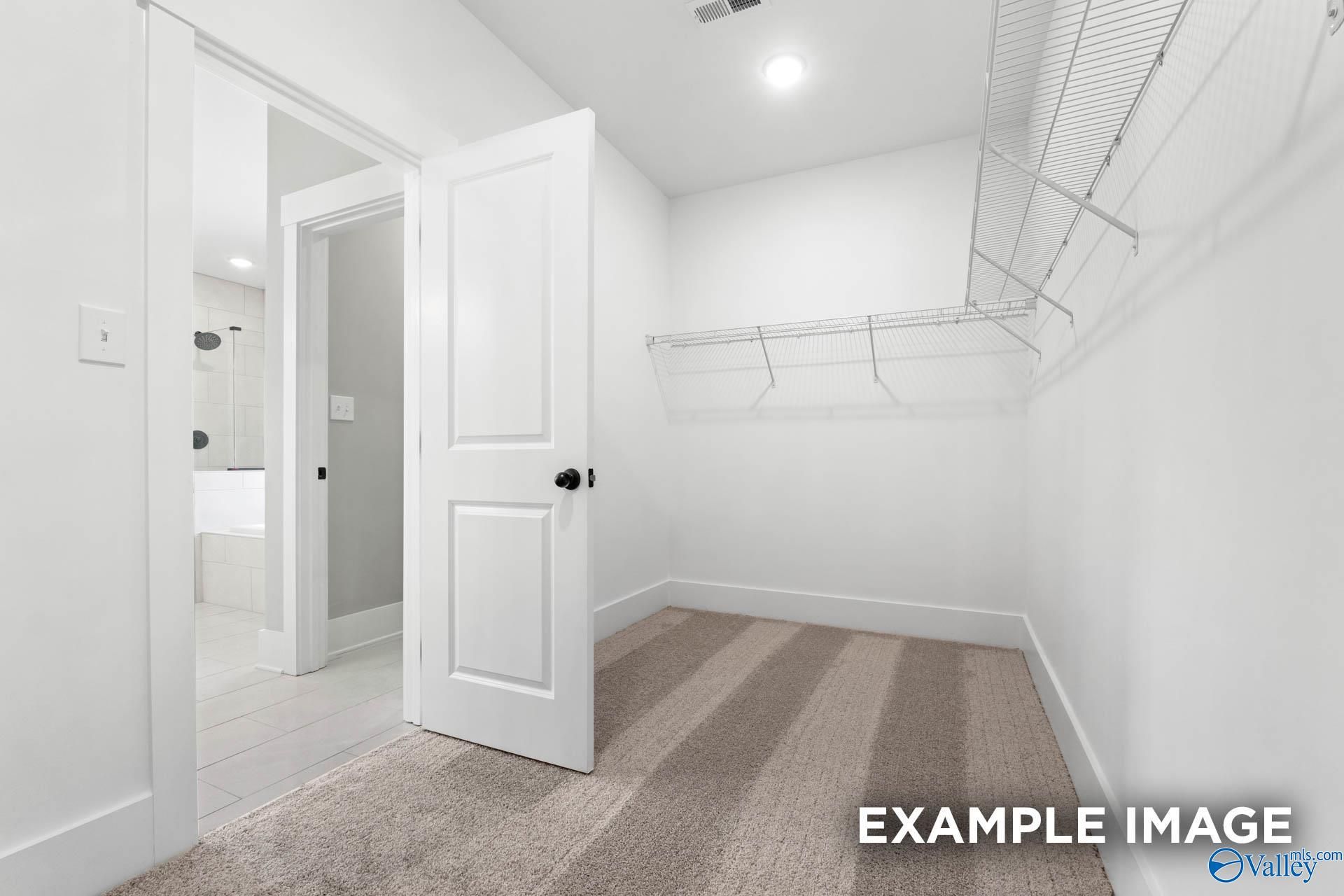 Walk-in closet with wire shelving in The Finleigh floor plan by Davidson Homes in Briercreek, Meridianville, Alabama.