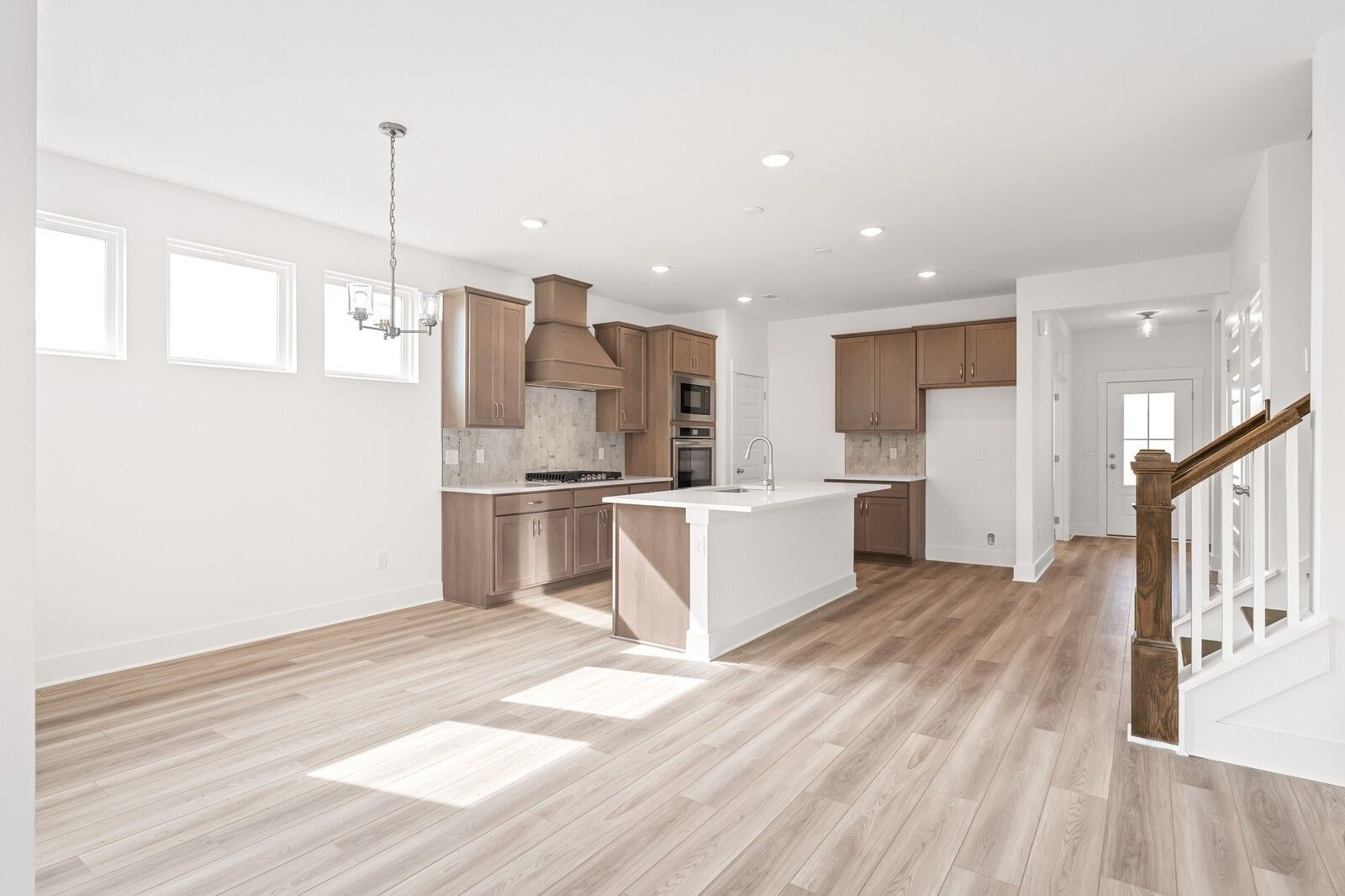 Modern open-concept kitchen with white quartz island, shaker cabinets, stainless appliances in Davidson Homes The Ash C, Mt. Juliet, TN