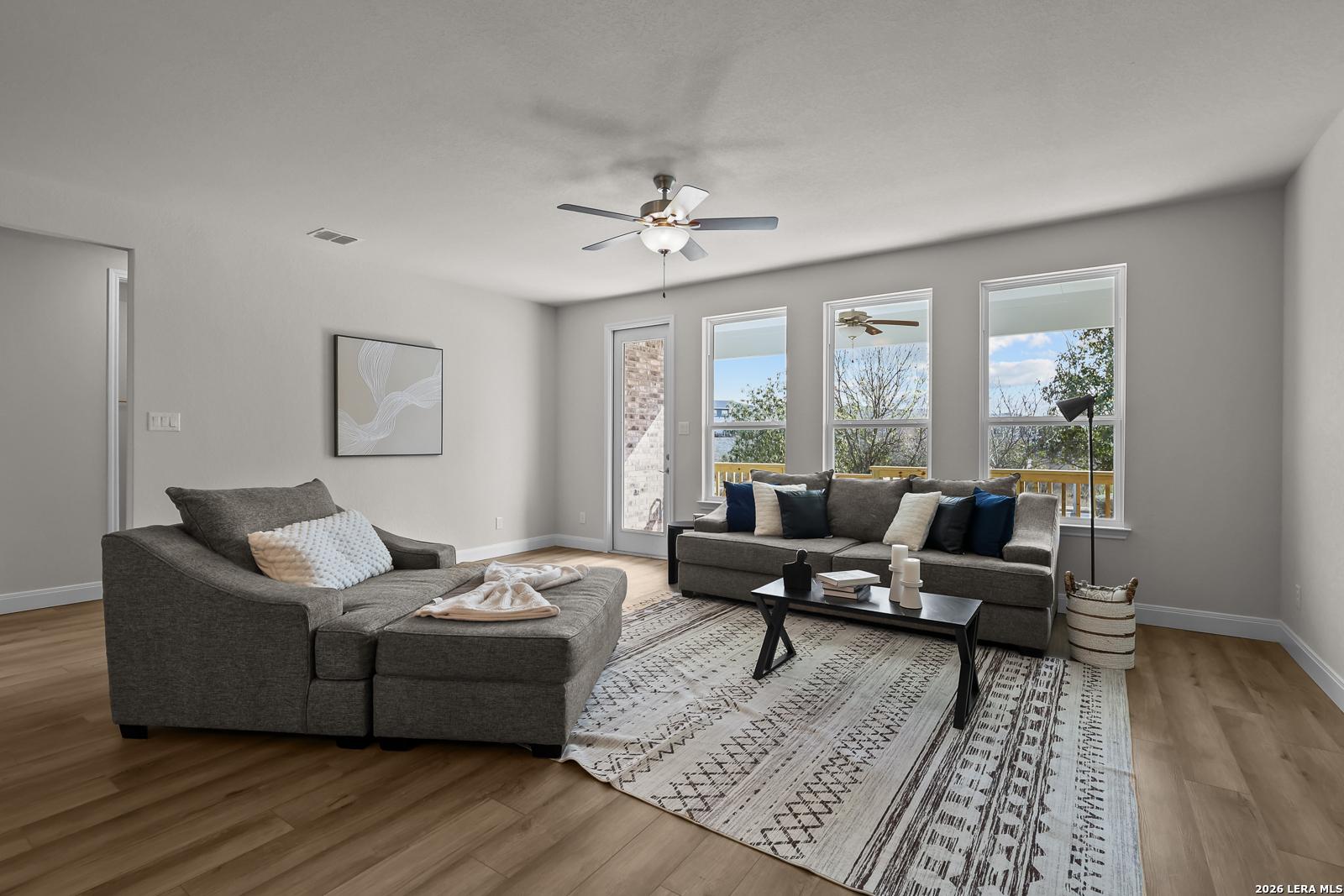 Bright living room in The Lanier H floor plan by Davidson Homes in Ladera, San Antonio, featuring light wood-style floors.