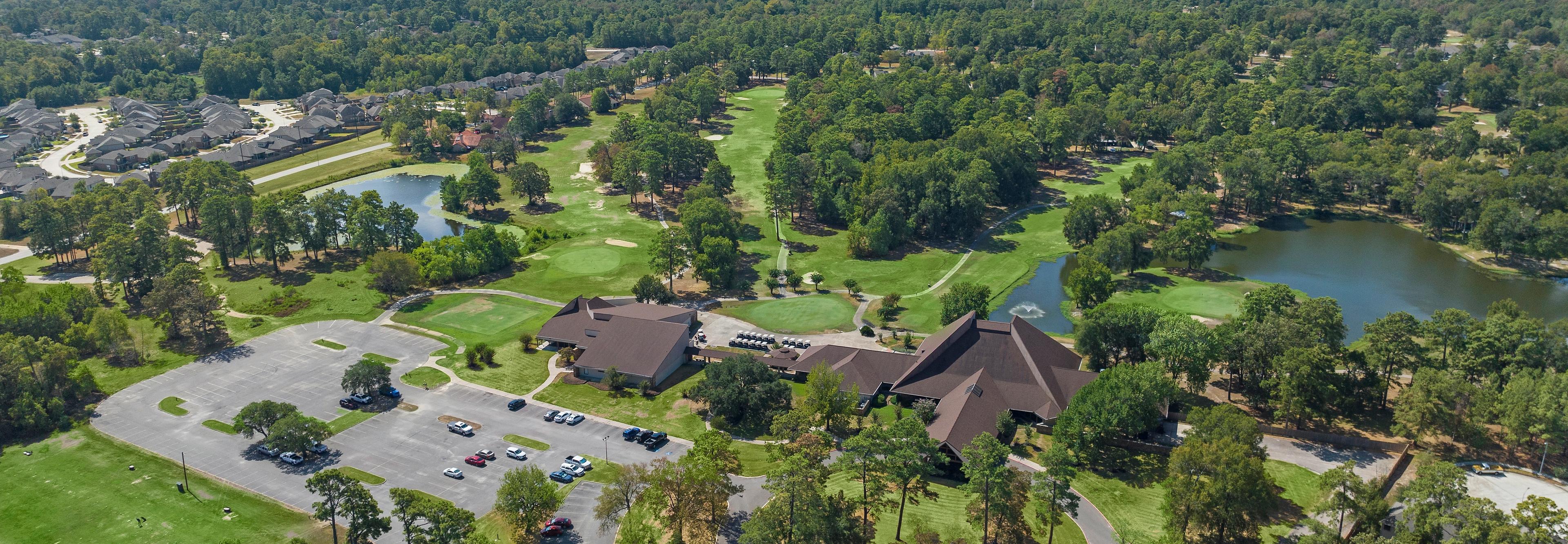 Aerial view of clubhouse pavilion, scenic lake, golf course, and lush greenery at Enclave at Newport in Crosby, Texas by Davidson Homes