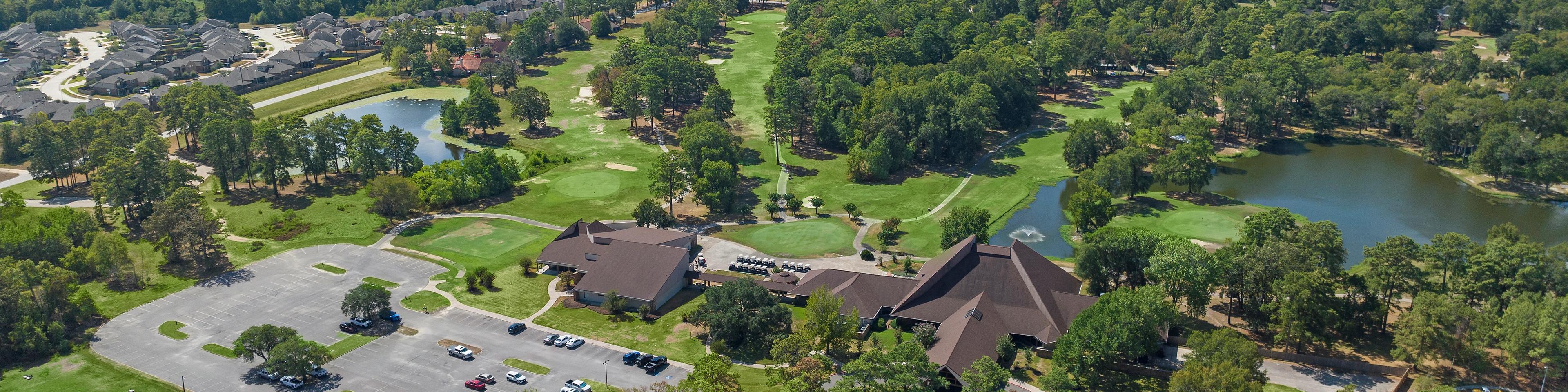 Aerial view of clubhouse pavilion, scenic lake, golf course, and lush greenery at Enclave at Newport in Crosby, Texas by Davidson Homes
