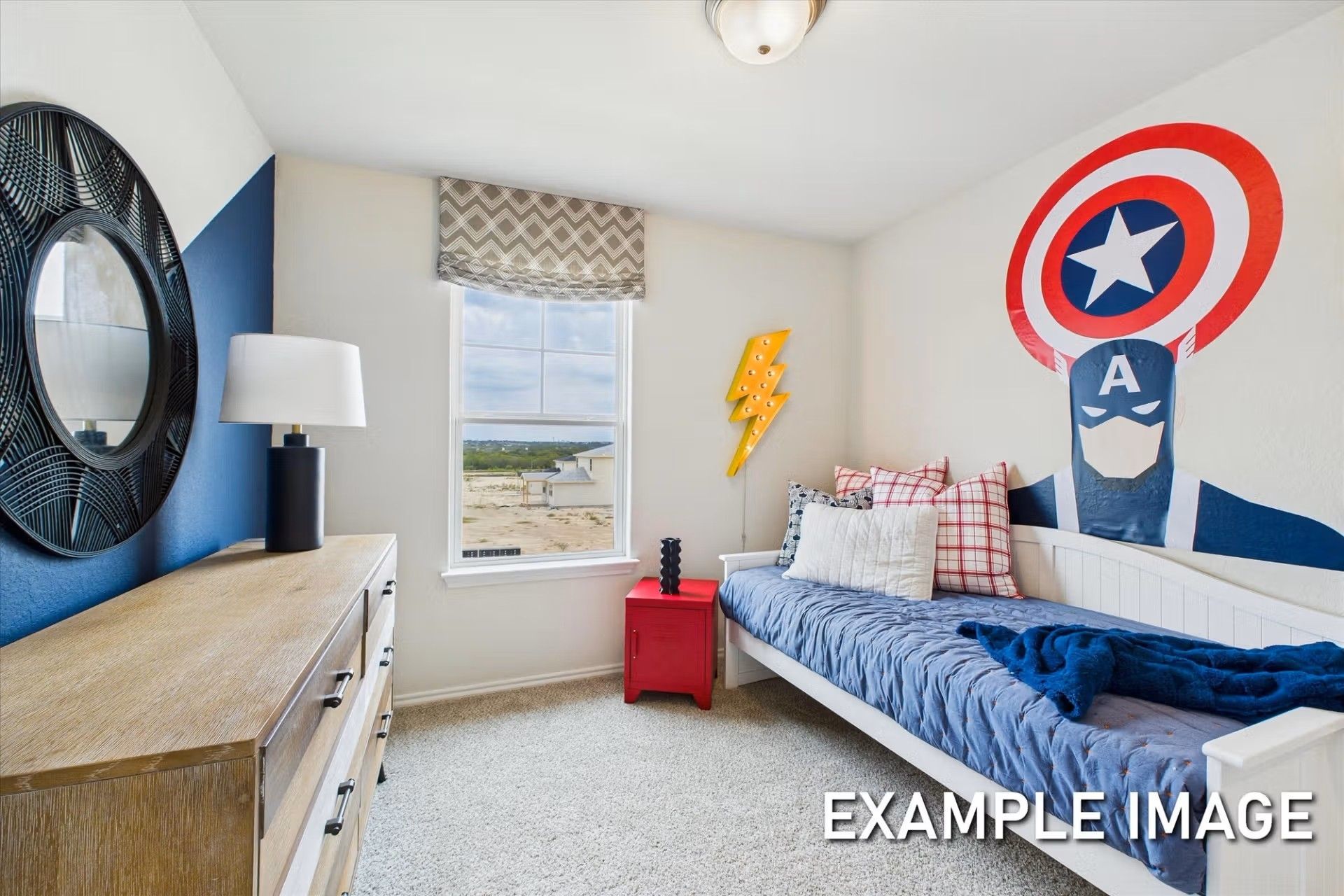 Superhero-themed bedroom with Captain America wall decal in The Brazos E floor plan at Davidson Homes in Heartland, Texas.