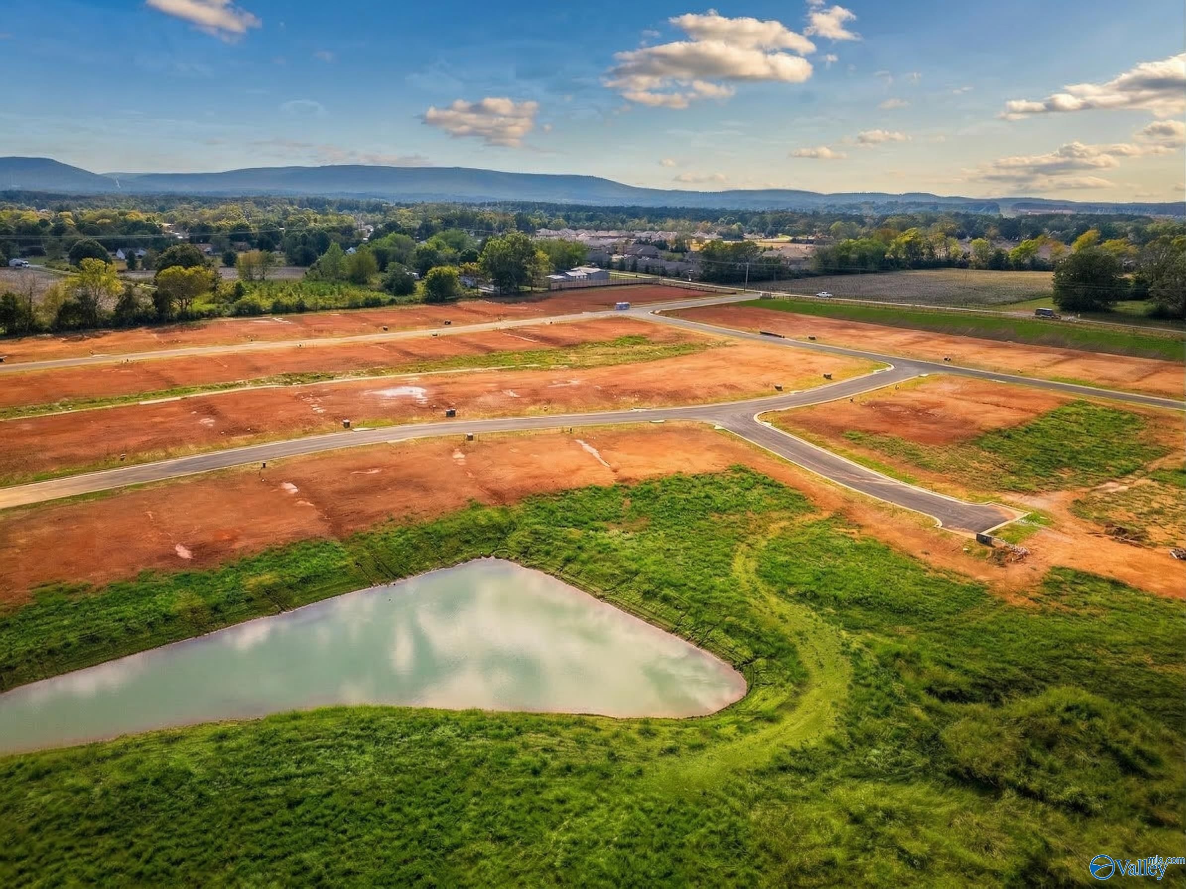 Aerial view of development land for new homes in Berry Cove, New Market, Alabama with scenic mountain views.