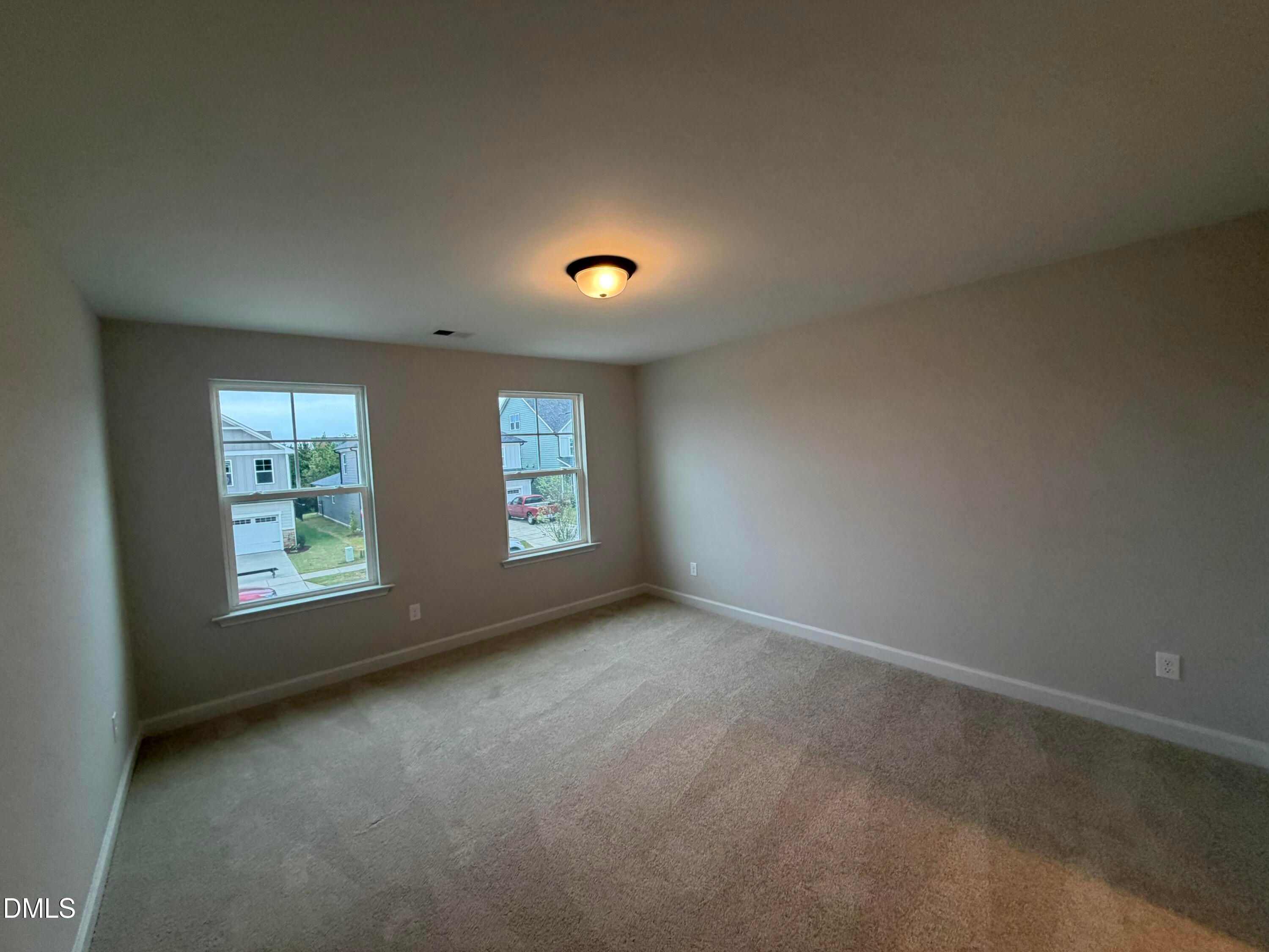Bright carpeted bedroom with double windows in Davidson Homes The Preston C, 4-bedroom new home in Wendell Ridge, NC