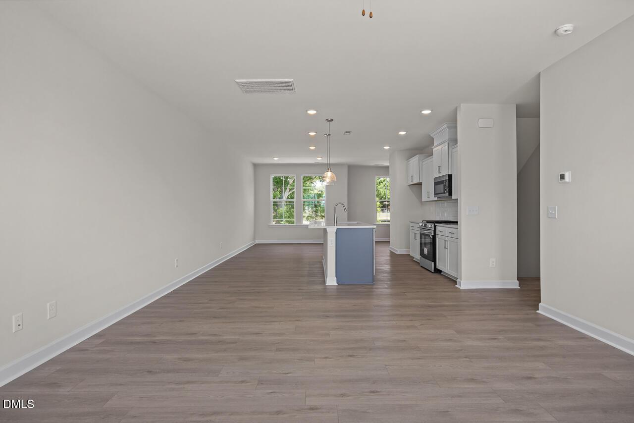 Open-concept kitchen and living area in The Mitchell floor plan at Camden Park, Knightdale, North Carolina.