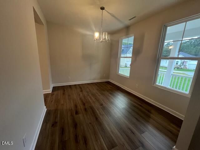 Bright dining room with hardwood-style flooring, chandelier, and large windows in Davidson Homes' The Willow D, Wellers Knoll, Lillington NC