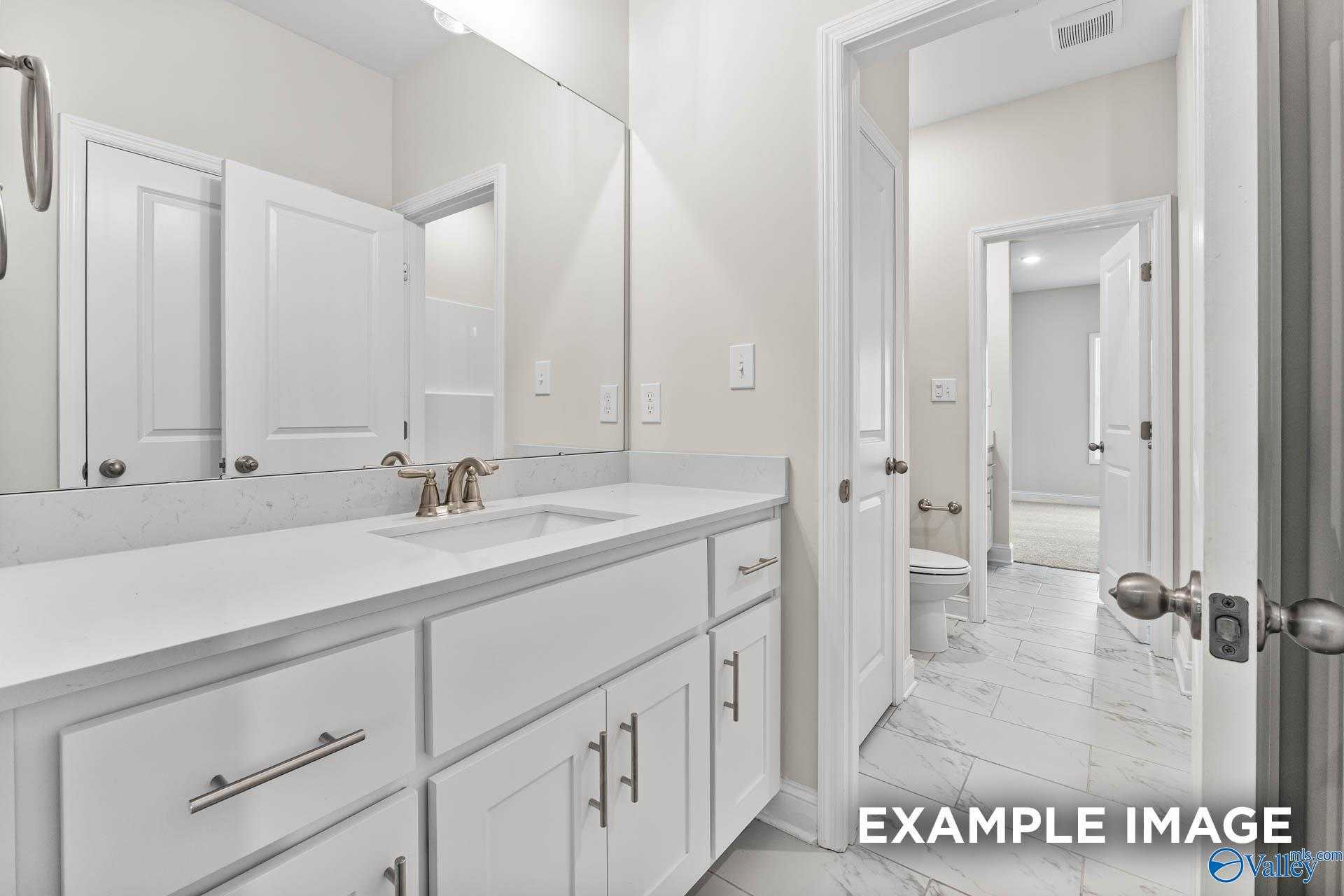 Modern double-sink vanity with white shaker cabinets and quartz counters in Davidson Homes The Finleigh, Meridianville, Alabama