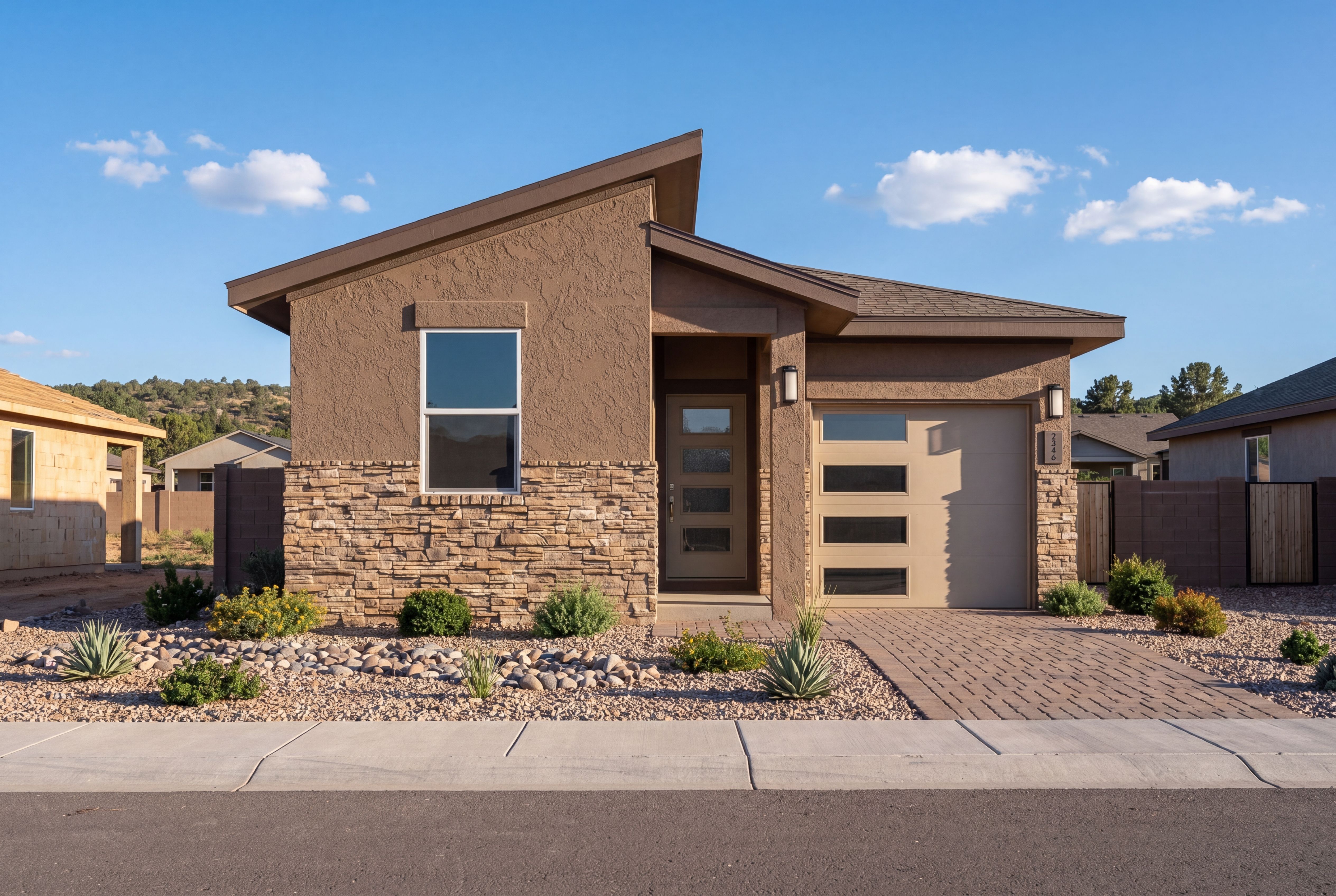 Modern exterior of The Savannah C in Prescott, featuring a 1-story design with stone accents and an attached garage.