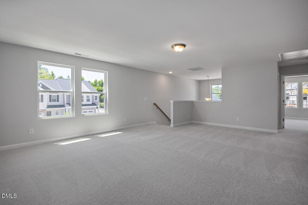 Spacious carpeted loft area in The Adalynn B floor plan by Davidson Homes in Gregory Village, Lillington, North Carolina.