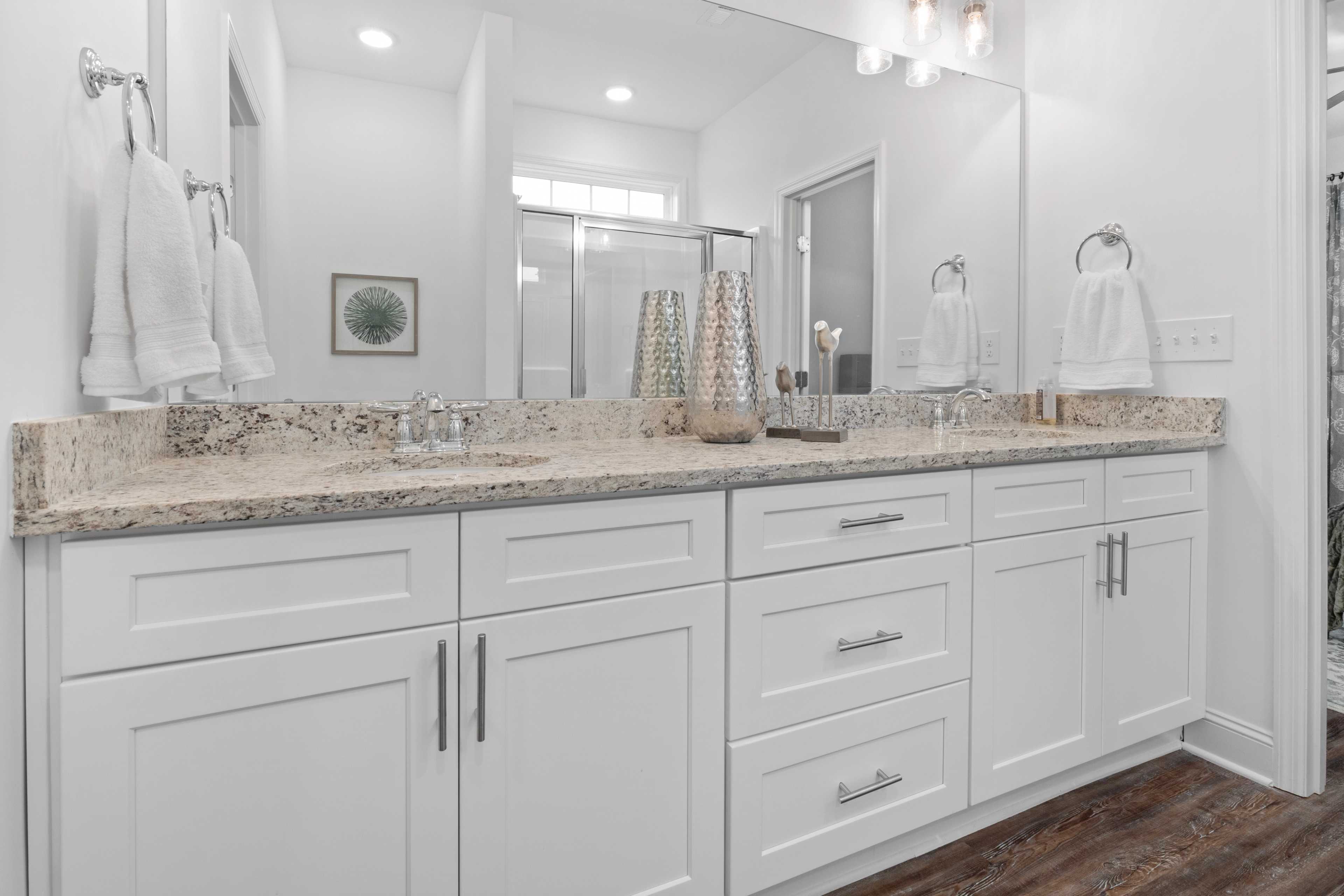 Spacious double-sink vanity in master bathroom at The Retreat at Hollon Meadow, Decatur AL with white shaker cabinets and quartz countertop