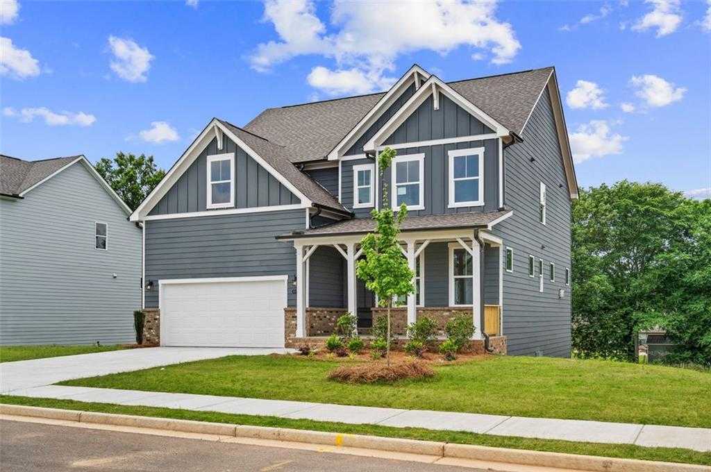 Two-story gray craftsman home with front porch, two-car garage, and landscaped yard, Davidson Homes The Hickory B in Wehunt Meadows, Hoschton, GA
