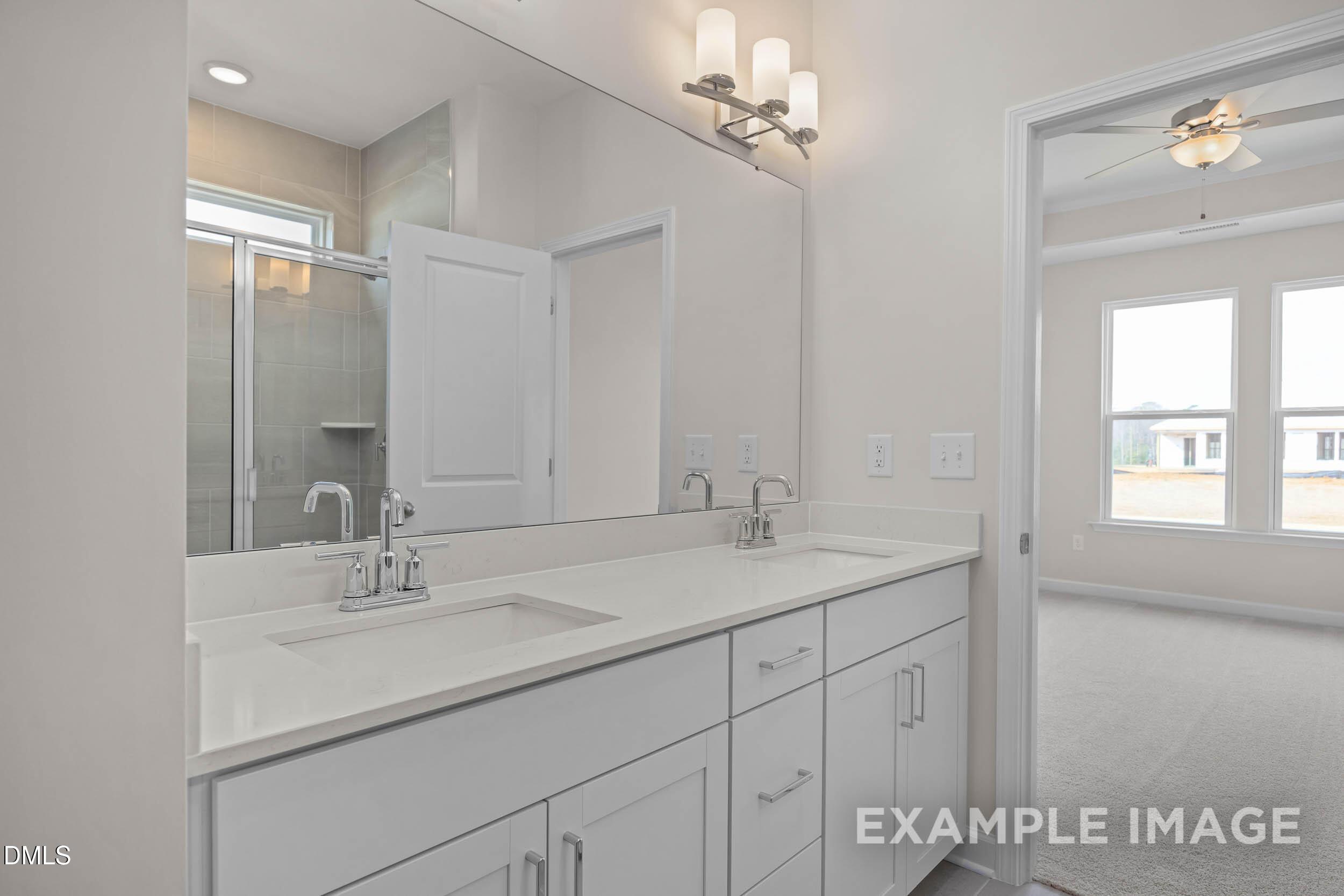 Modern double vanity with white cabinets and quartz countertops in Davidson Homes Franklin C floor plan, Lillington, NC.
