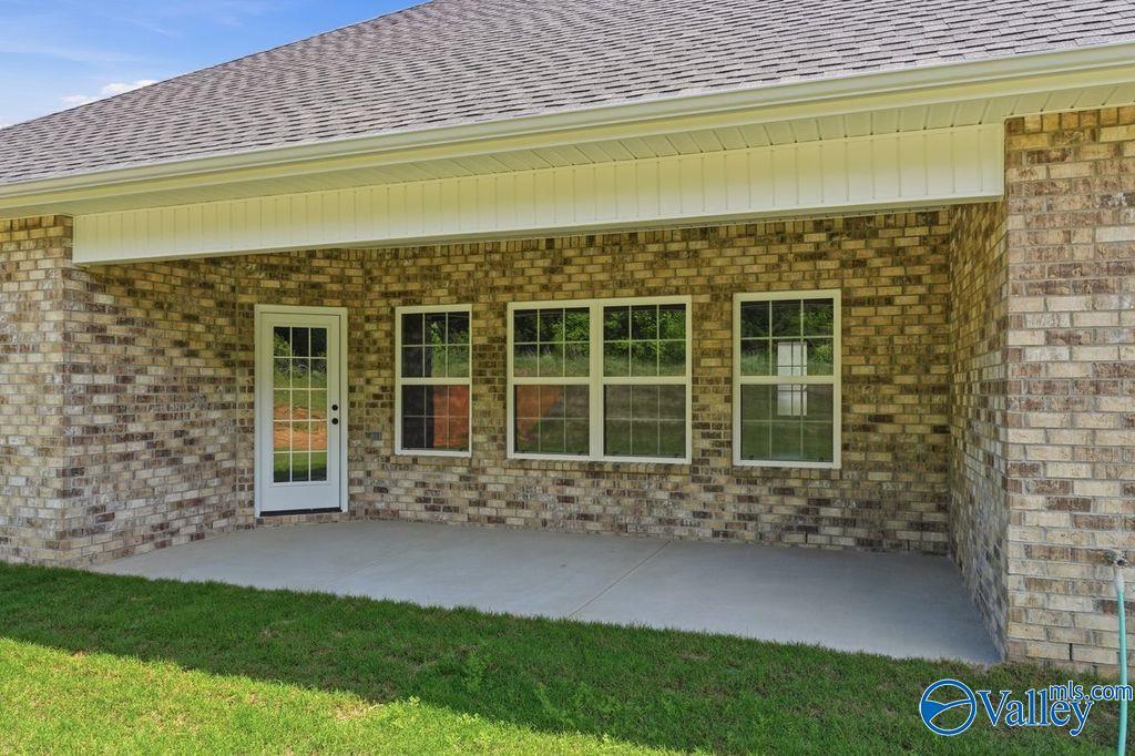Covered back patio with brick exterior on The Rockford floor plan at Cain Park in Hartselle, Alabama.