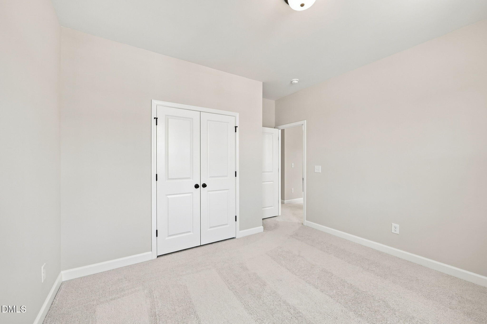 Bright secondary bedroom with carpet and double-door closet in The Harris C floor plan, Forestville Yard, Knightdale, NC.