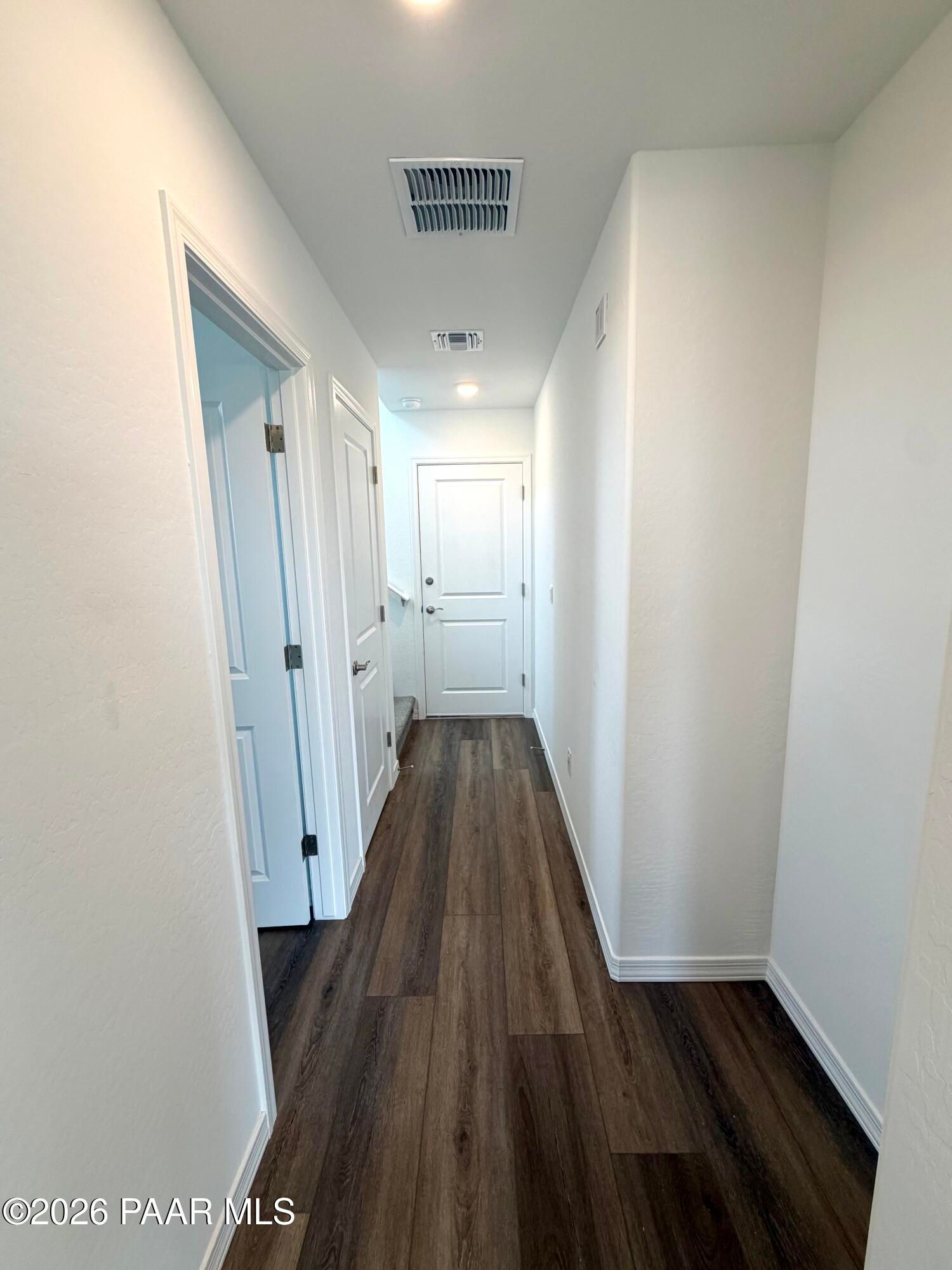 Bright hallway with wood-look flooring in The Raleigh A floor plan at South Ranch Southern Collection, Prescott, Arizona.