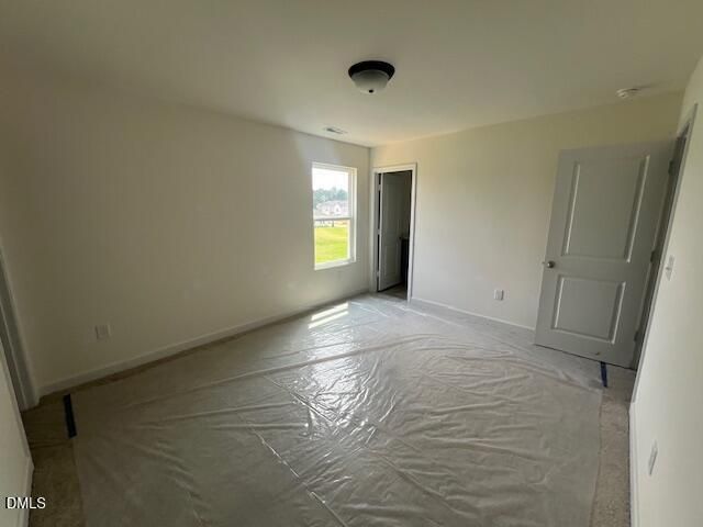Spacious bedroom with protective floor covering in The Hickory II B floor plan at Retreat at North Main, Lillington, NC.