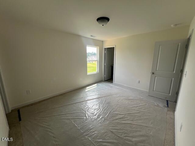 Spacious bedroom with protective floor covering in The Hickory II B floor plan at Retreat at North Main, Lillington, NC.