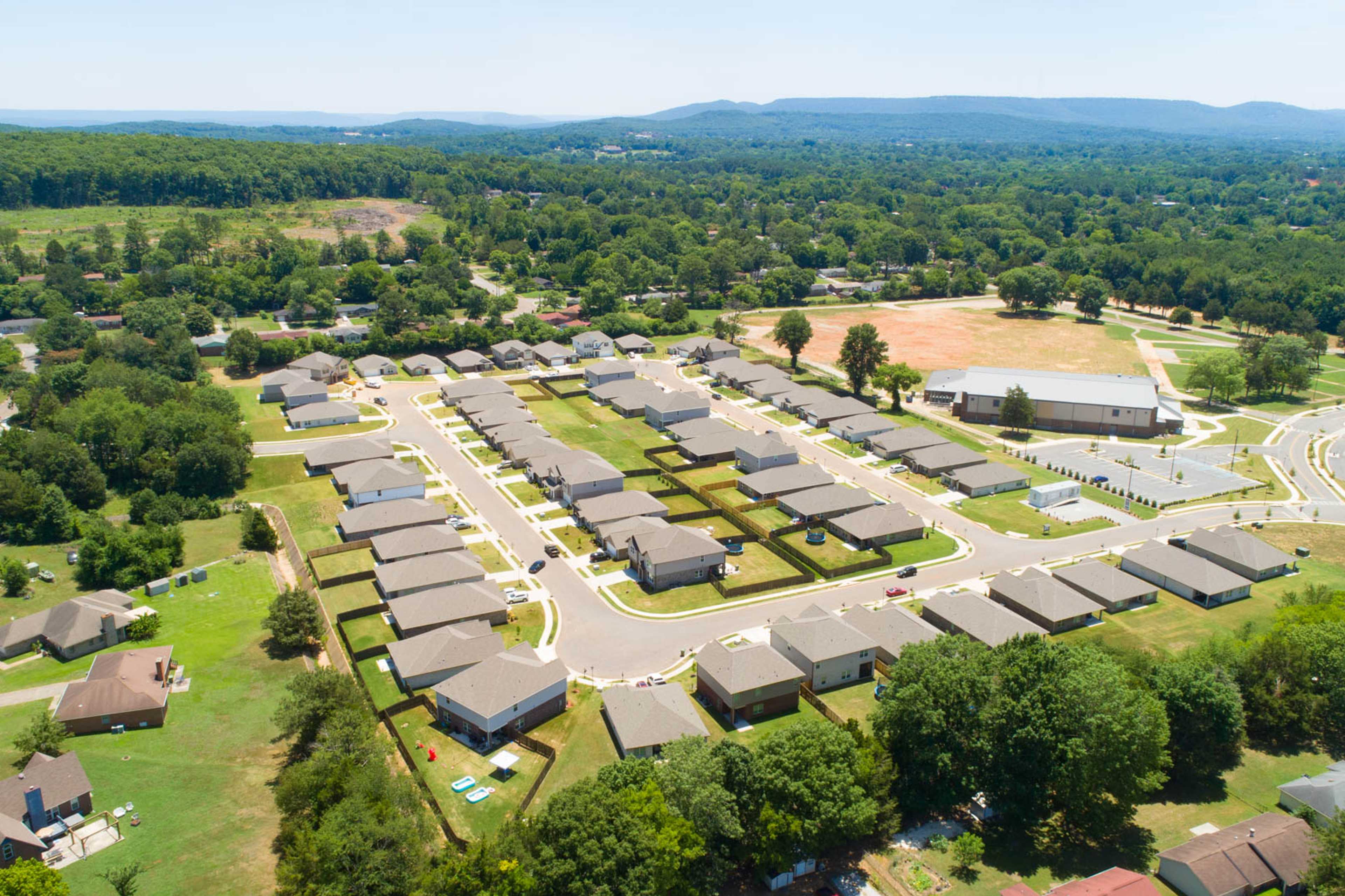 Aerial view of Jaguar Hills neighborhood in Huntsville Alabama by Davidson Homes featuring new ranch-style homes and lush green landscapes