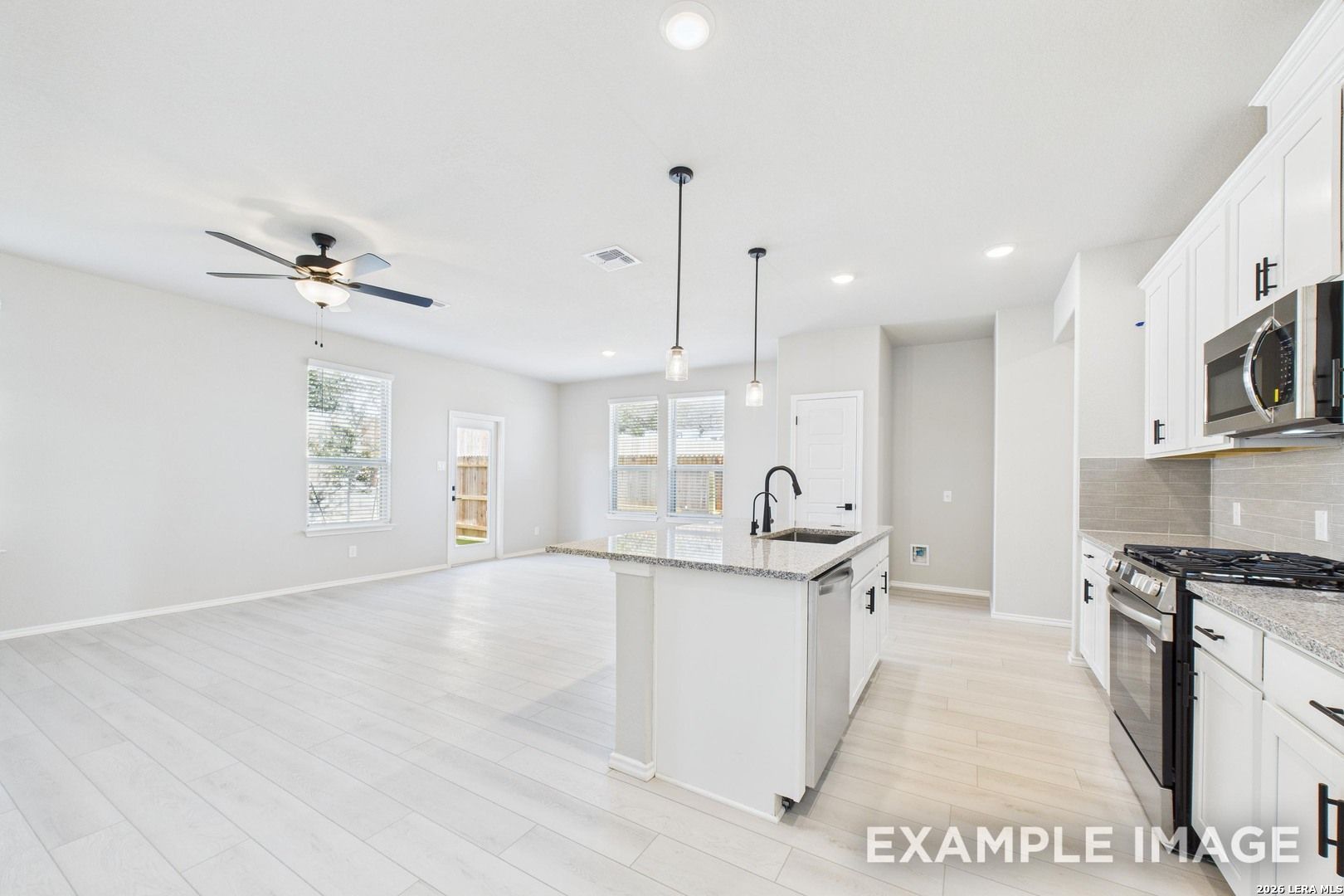 Open-concept kitchen and living area in The Charlotte B floor plan by Davidson Homes in Cedar Heights, San Antonio.