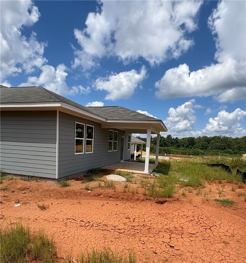 Exterior view of The Phoenix D floor plan by Davidson Homes featuring a covered back patio in Anderson Lakes, Opelika, AL.
