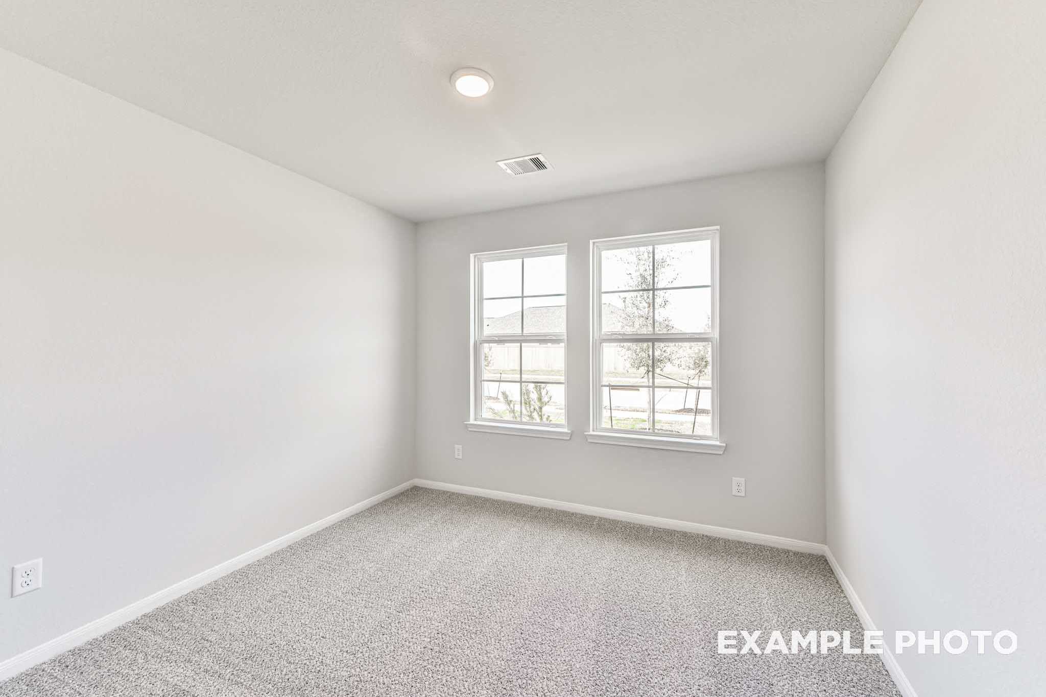 Spacious secondary bedroom in The Laguna A with gray carpet, neutral walls, double windows, and recessed lighting