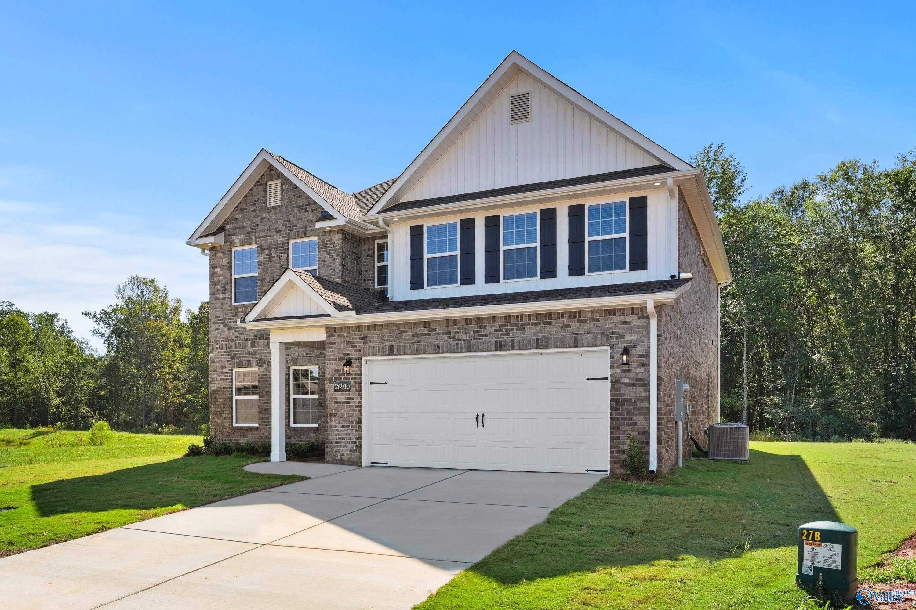 Two-story brick home with 2-car garage, front porch, and green lawn in Davidson Homes The Shelby A, Ricketts Farm, Athens, AL